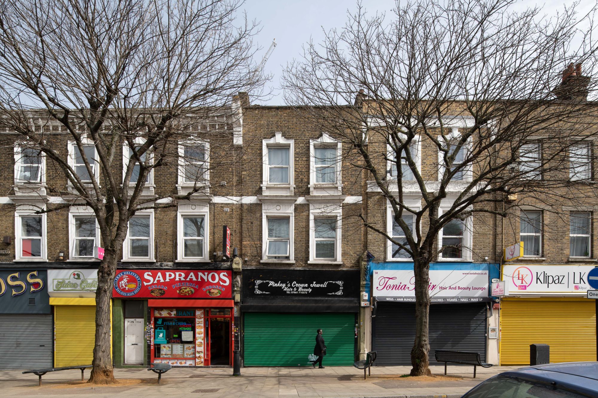 Photograph of a street scene with colourful shopfronts.