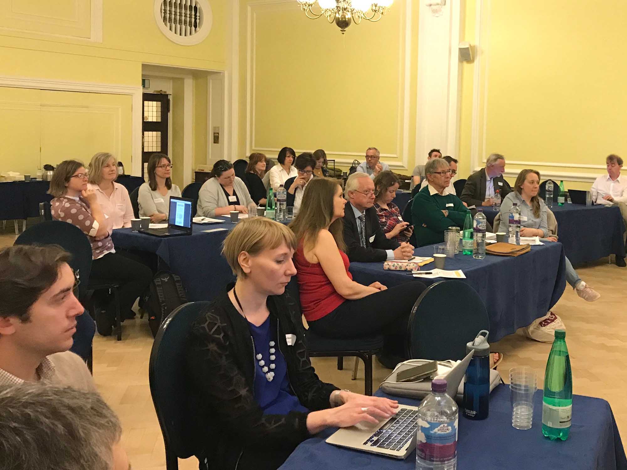 Image of a group of members at an IHBC hosted event seated at tables for groupwork.