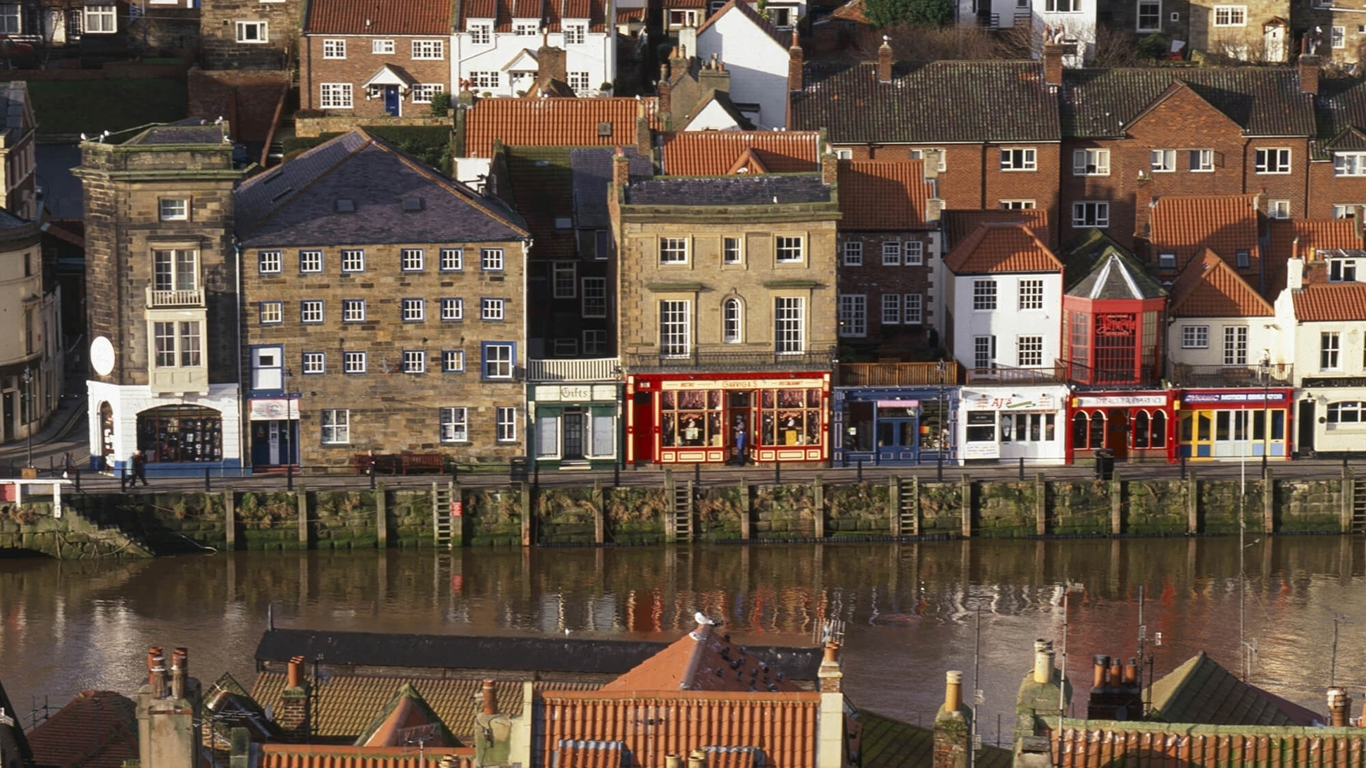 Whitby old town from east with red pantile roofs & harbour frontages