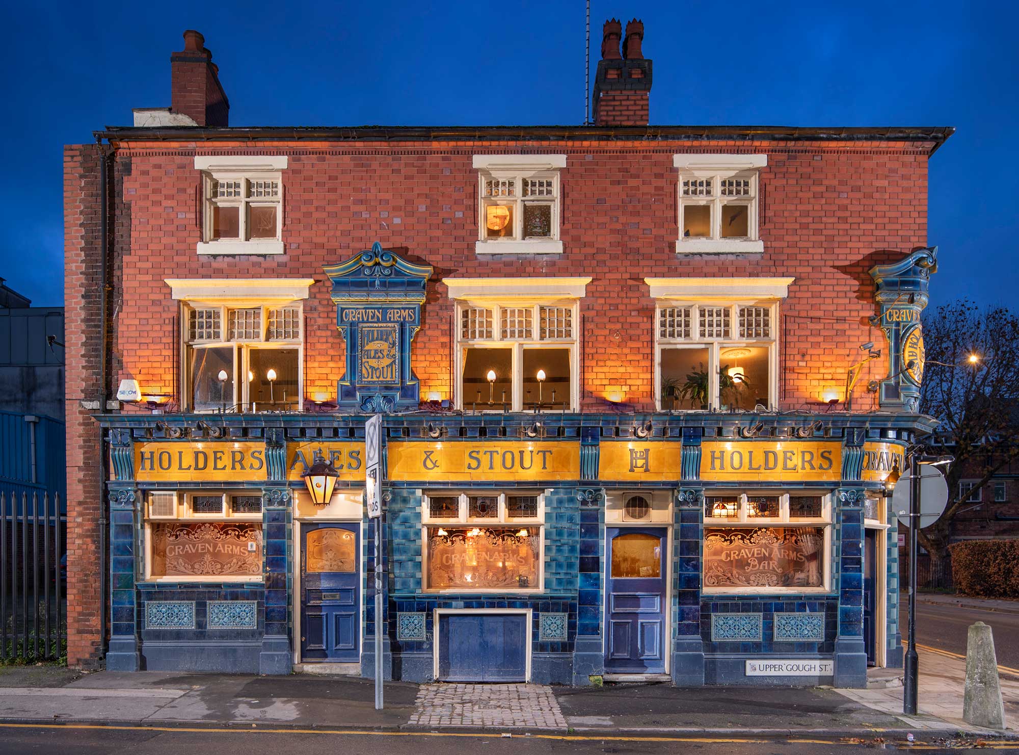 View of a pub lit up at dusk.