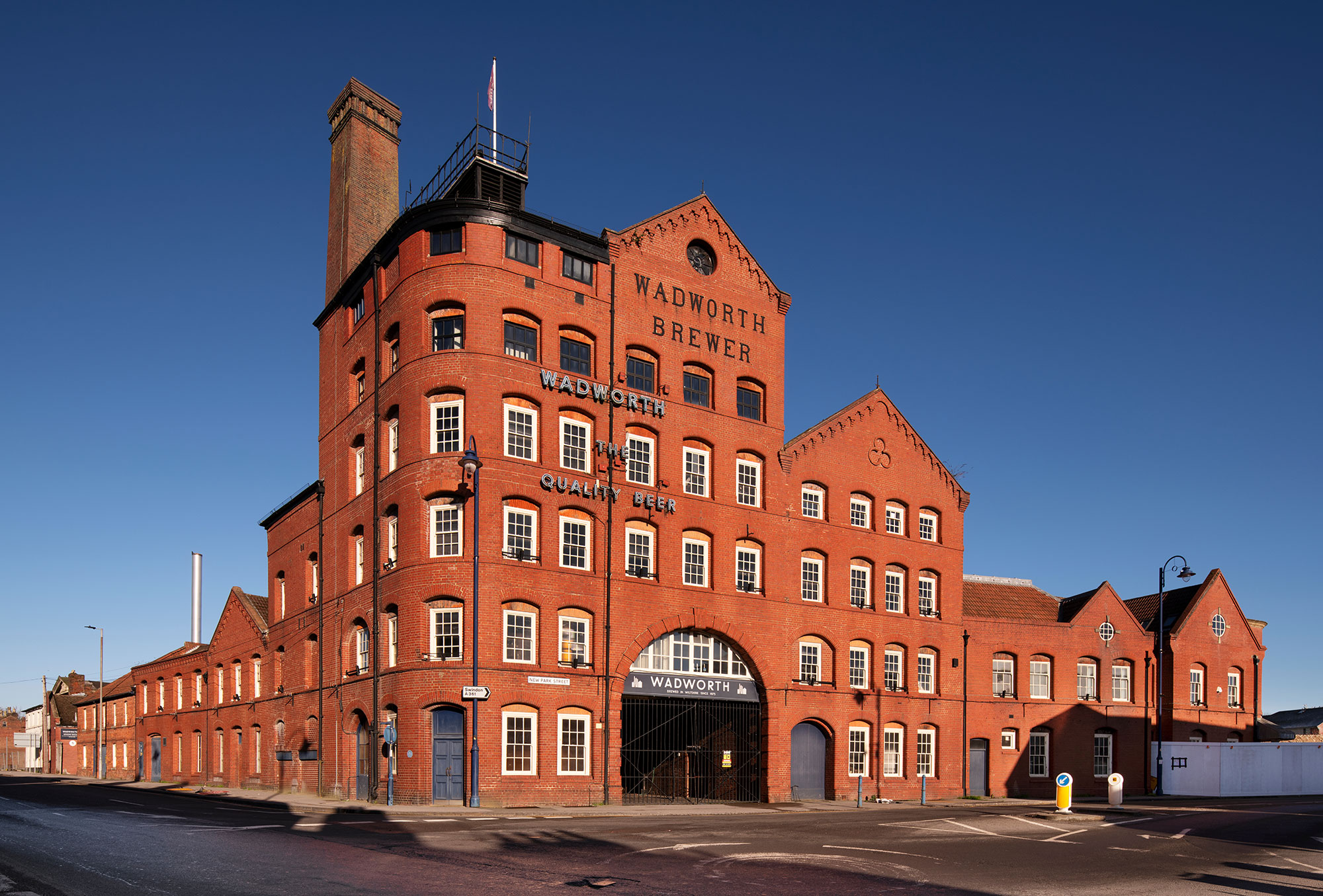 Red brick building with varying storeys and sash windows.