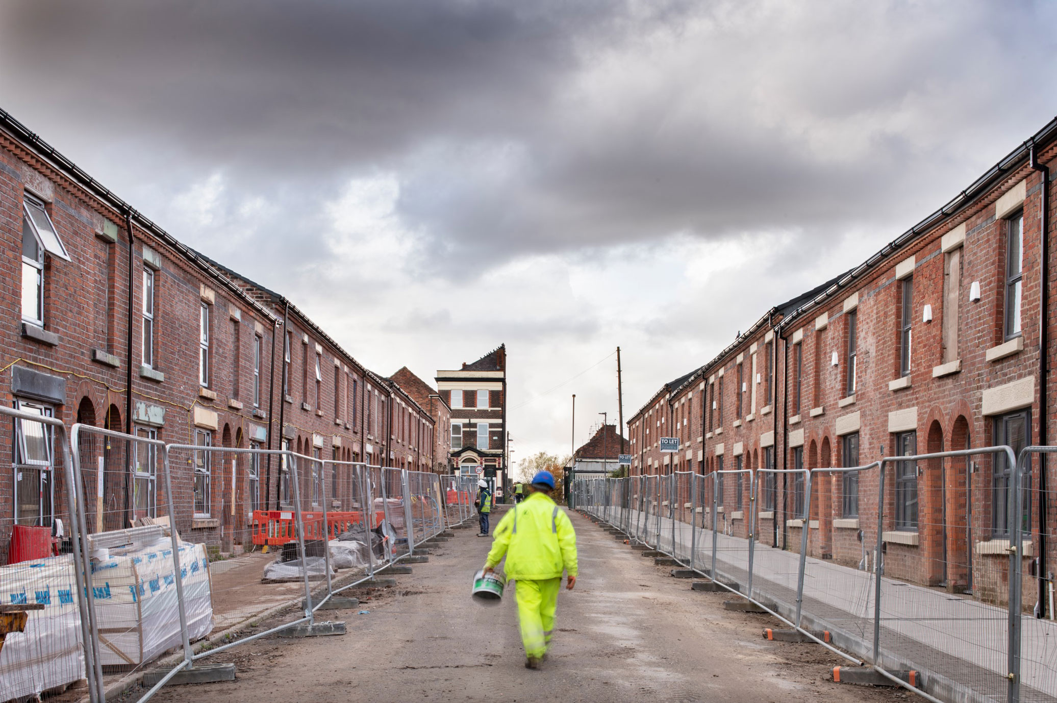 Workers restoring traditional terraced housing.