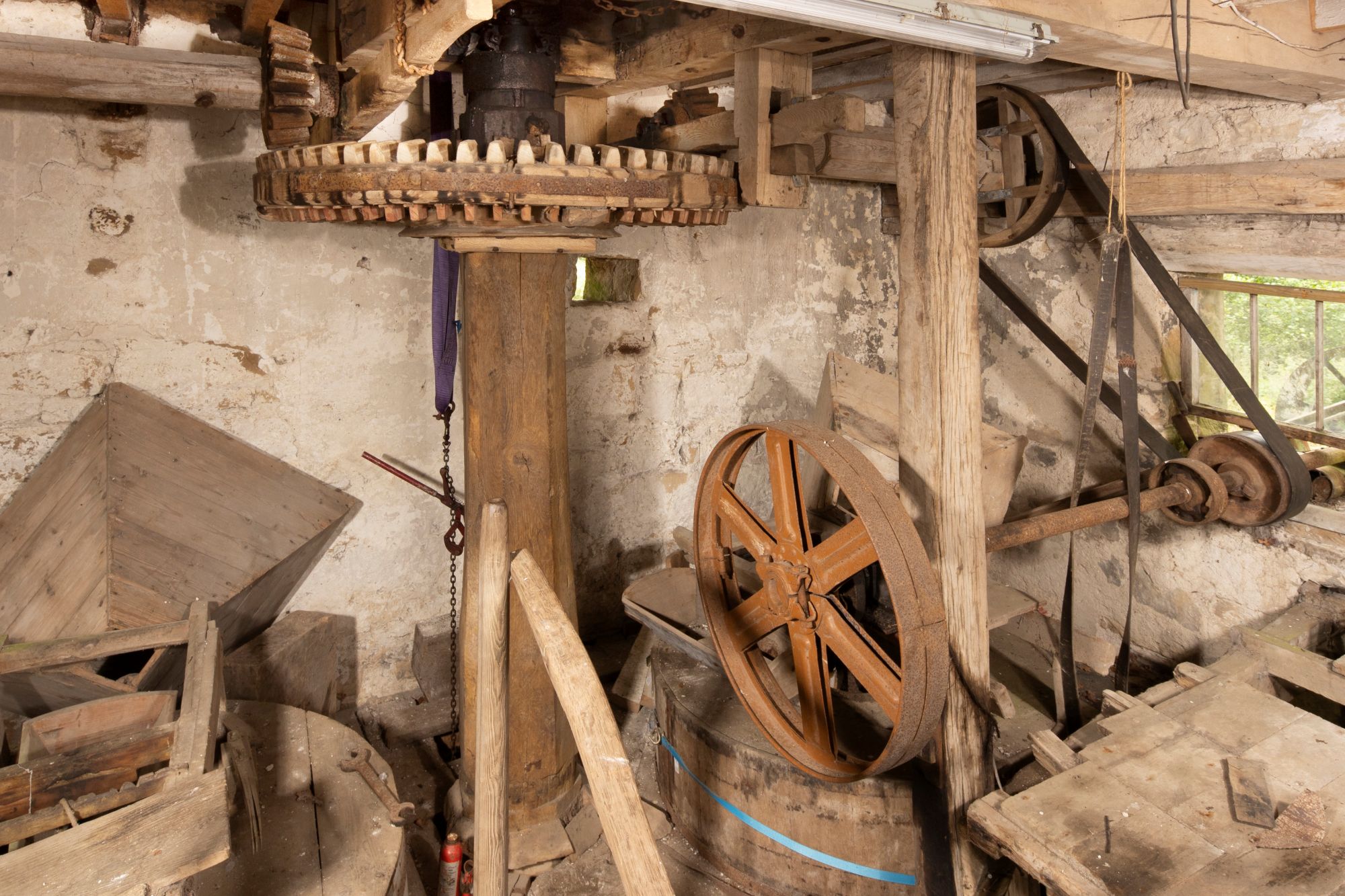 Photo of old wooden machinery that operates a mill.