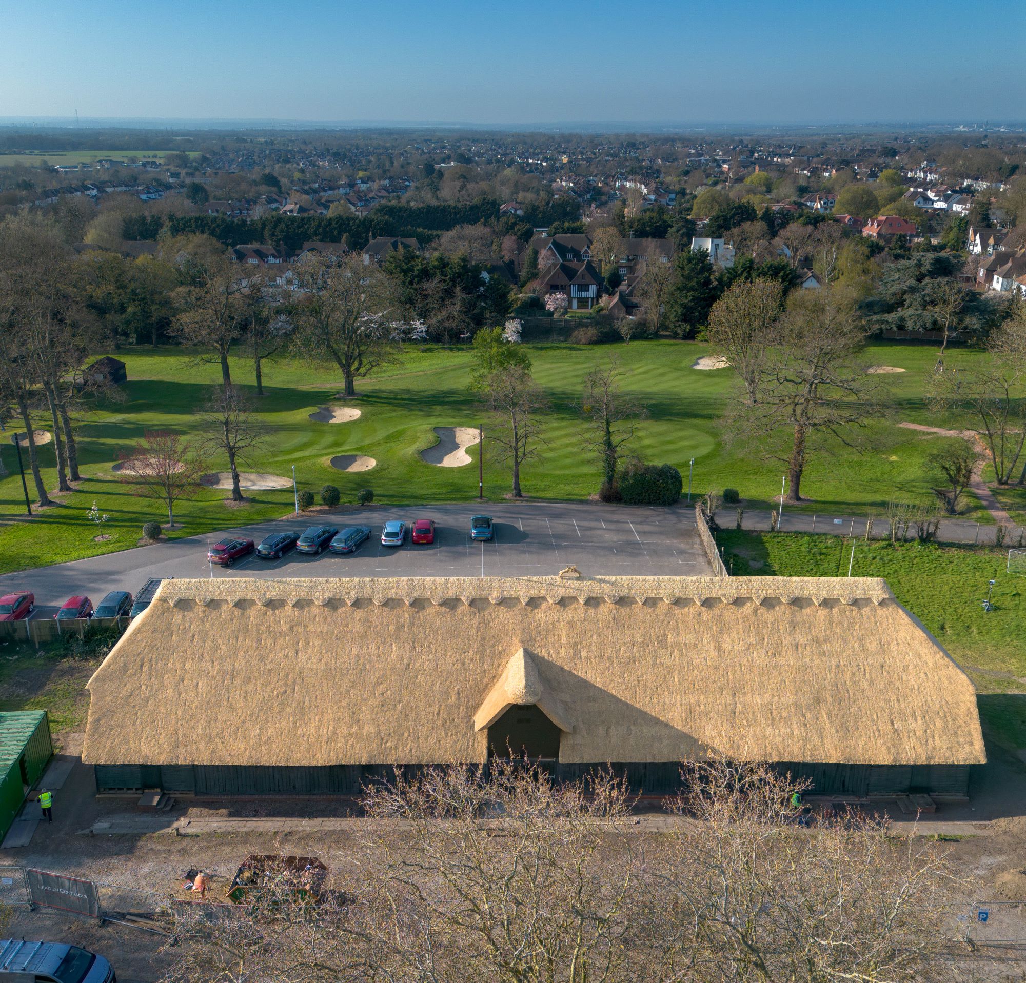 Aerial view of a long thatched barn building