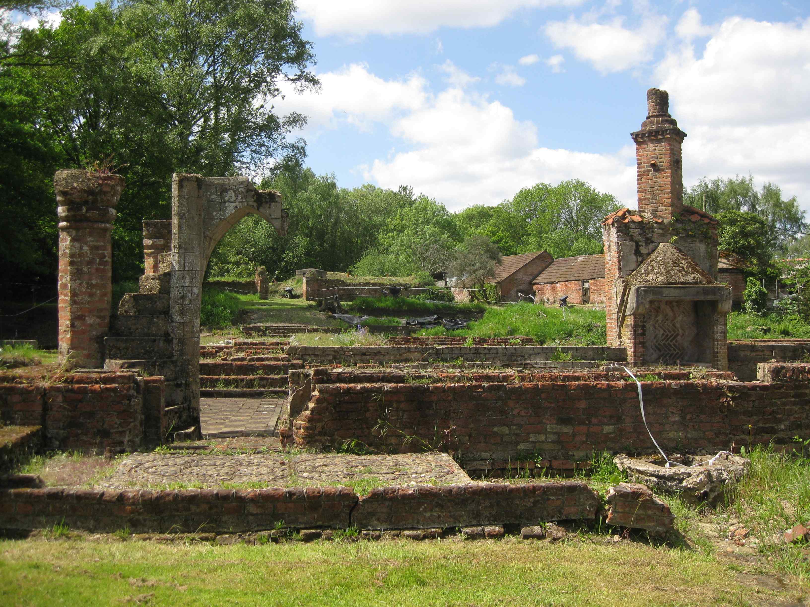 View of a green landscape with ruined brick structures