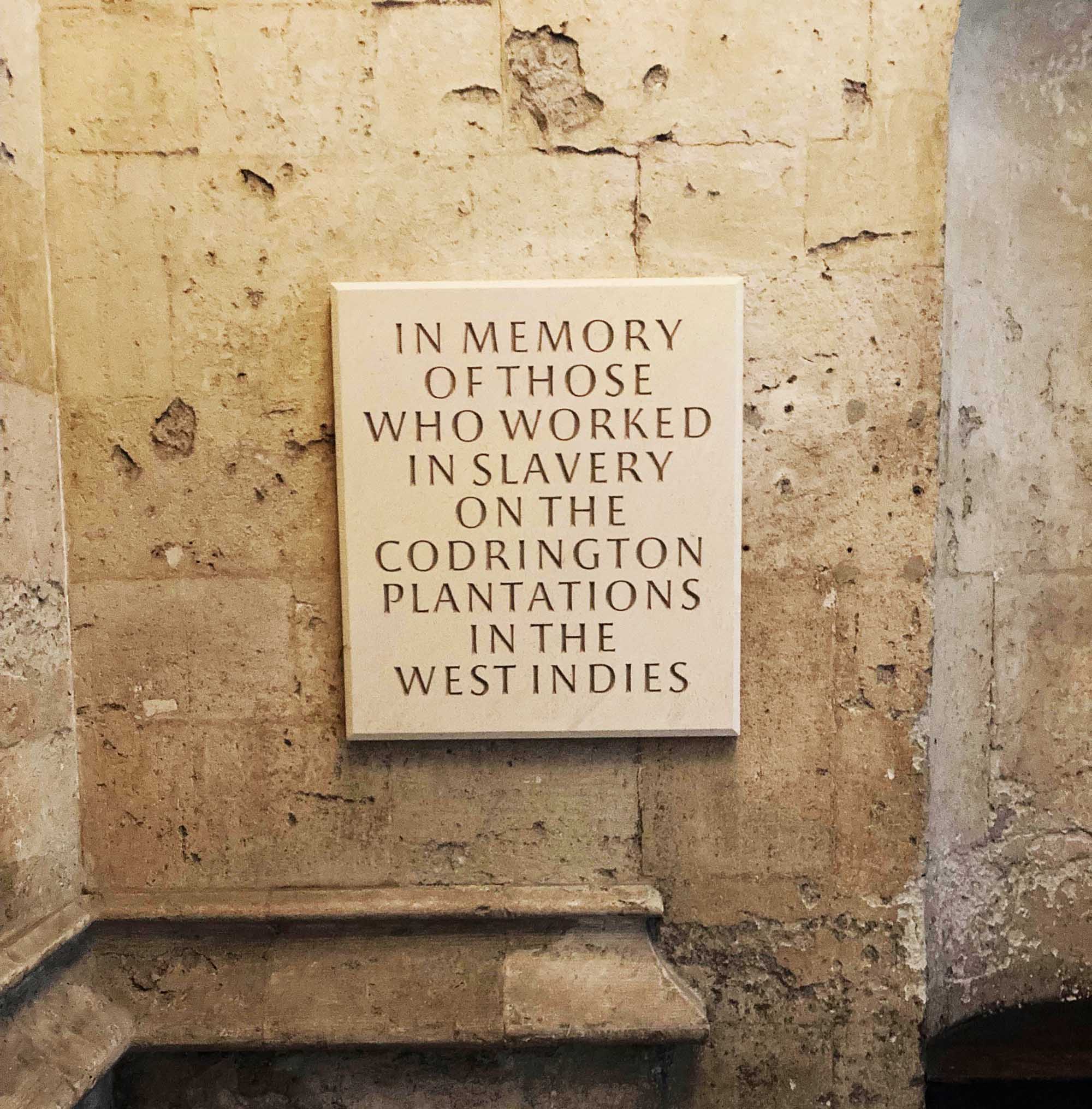 Detail of a stone plaque. The Inscription reads: "In memory of those who worked in slavery on the Codrington Plantations in the West Indies".