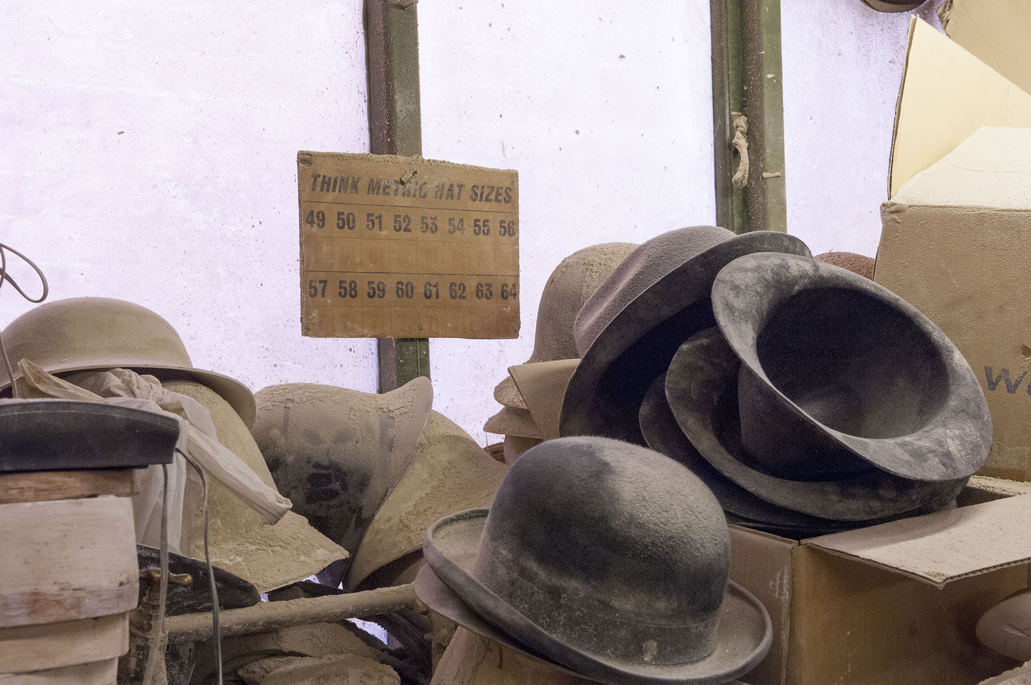 Dusty hats sit forgotten inside Boon and Lane Ltd, a blockmakers in Luton.