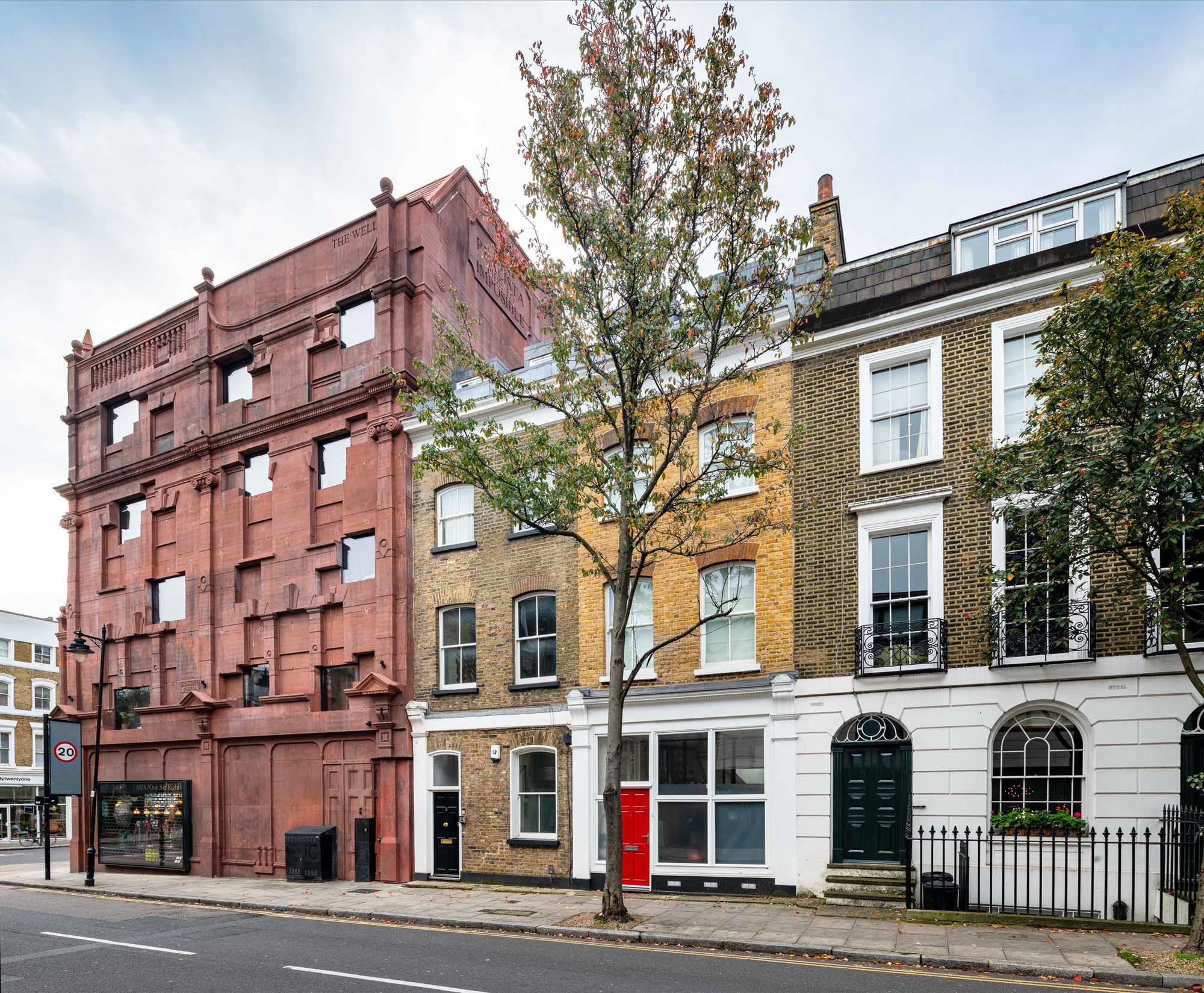 The facade of a reinstated four-storey ashlar Victorian building with adjacent properties.