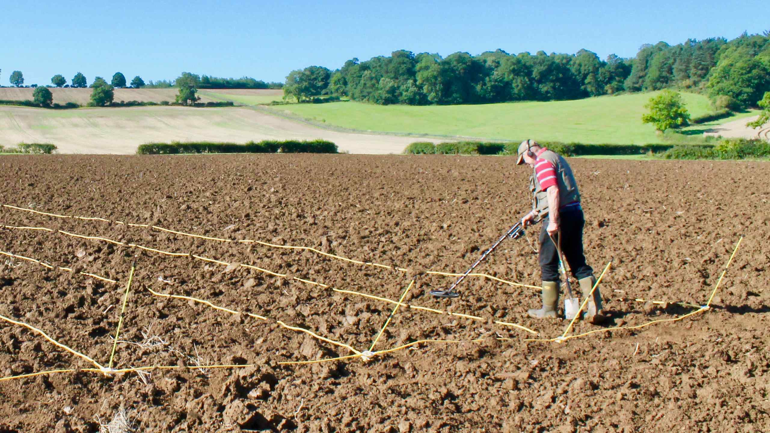 Metal detectorist in a field