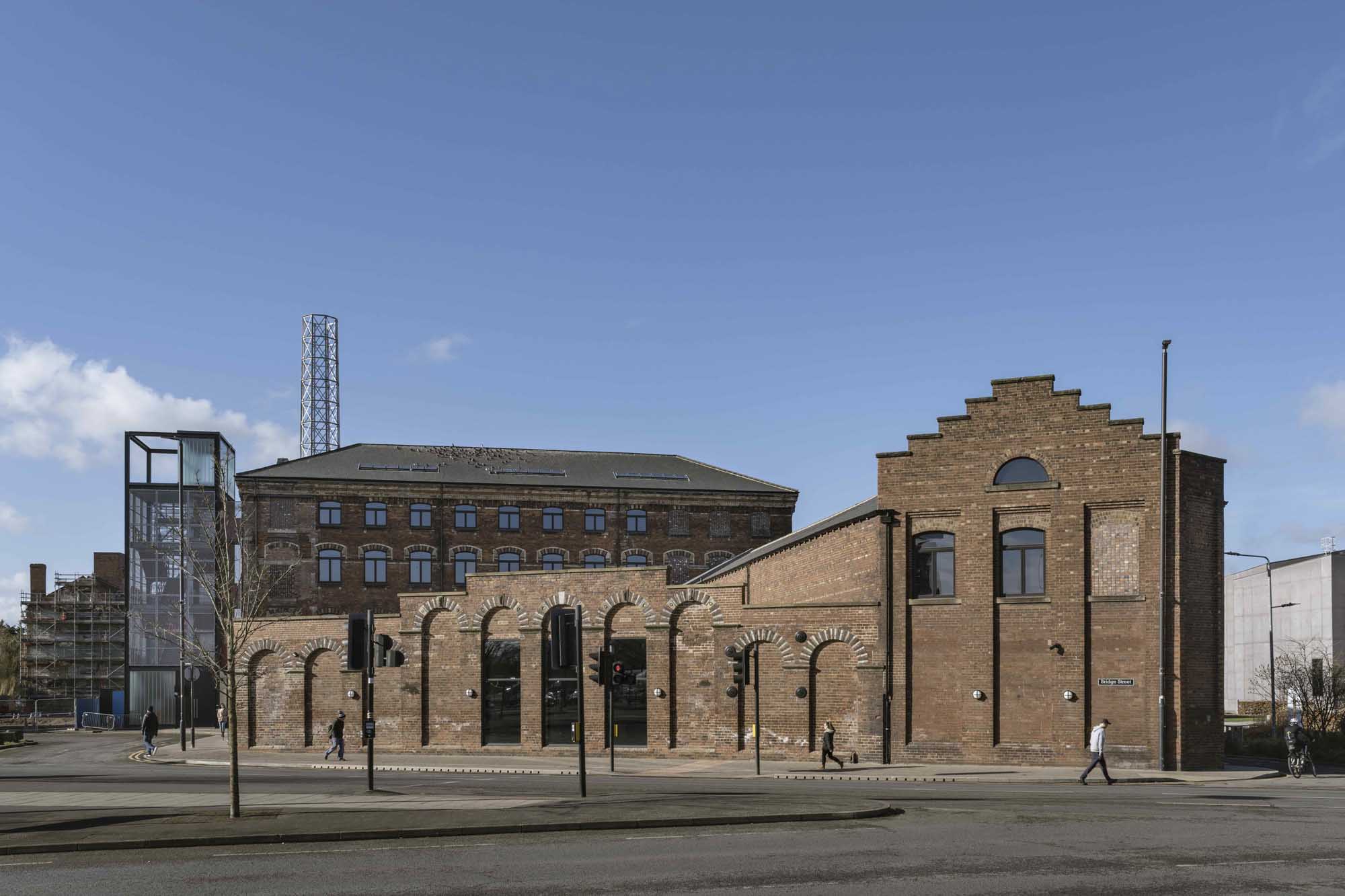 A collection of brick buildings next to a road. 