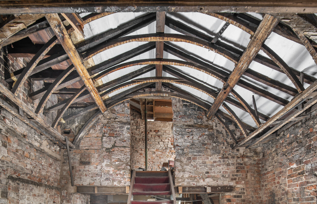 A wooden frame under a ceiling.