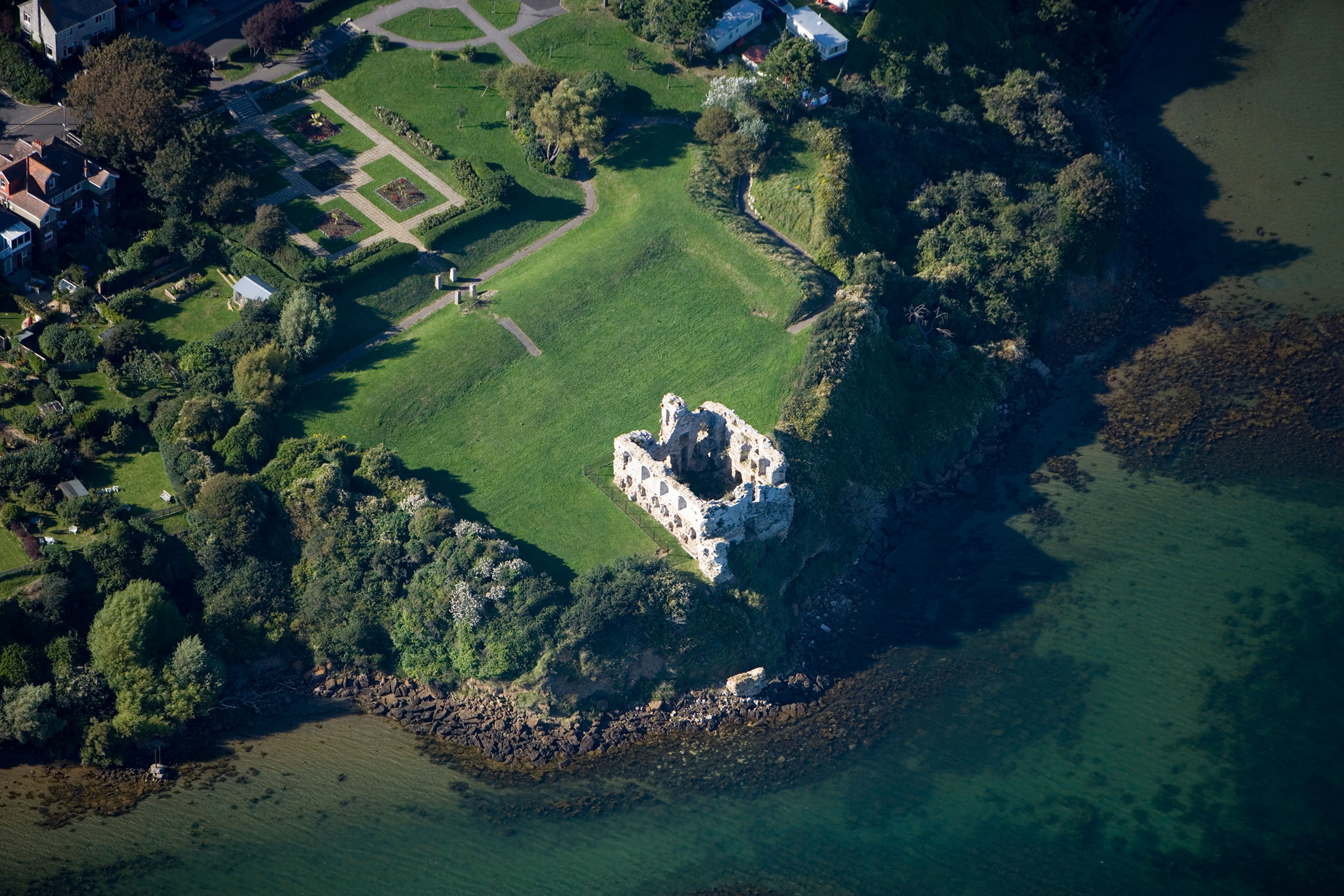 Birdseye view of a white castle building surrounded by grass and trees