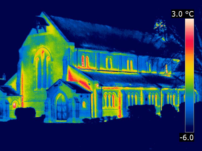A thermal image of a church with a temperature gauge on the right hand side showing warm areas as red and cold areas as blue.
