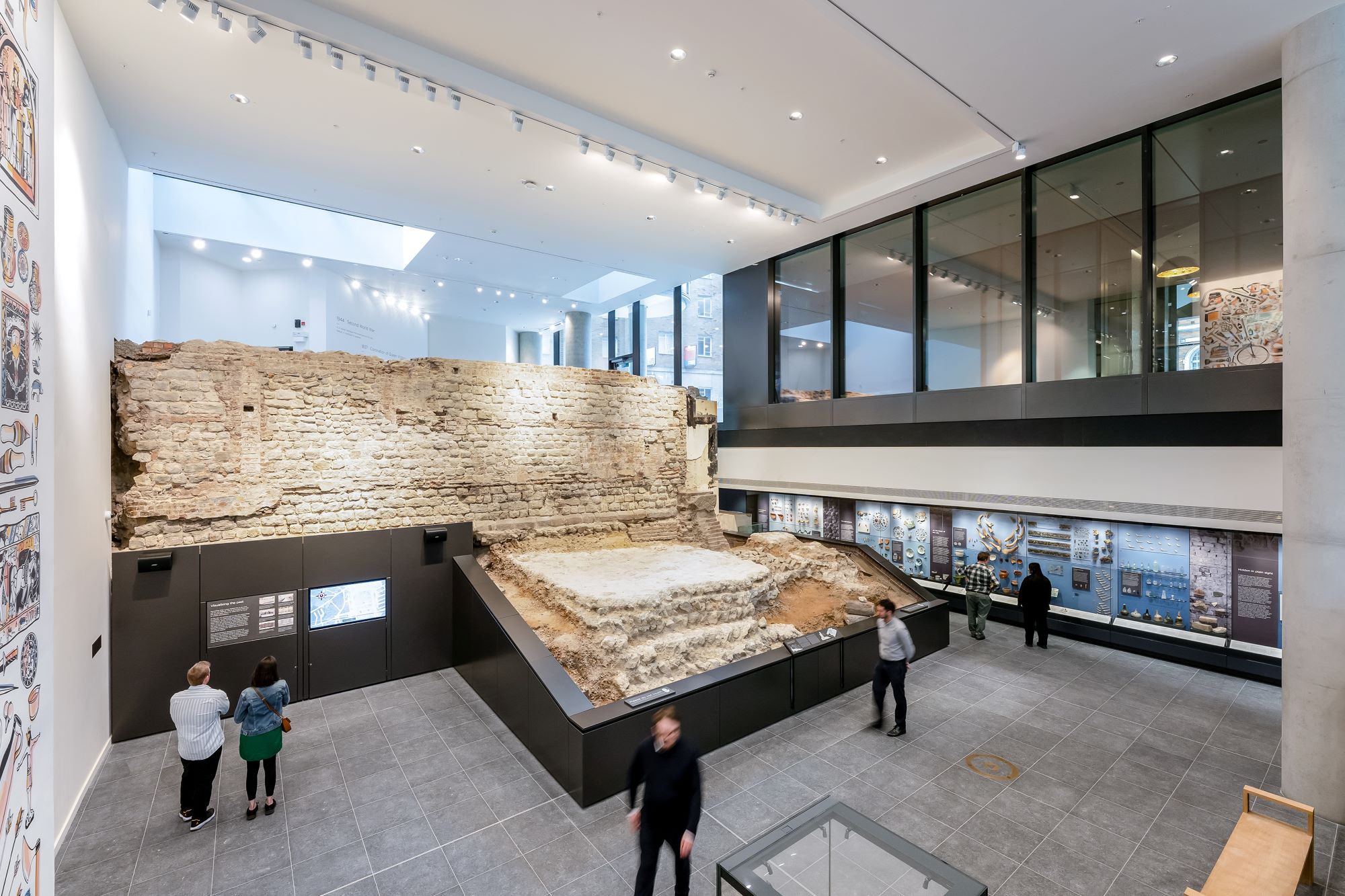 A photo of a large section of stone masonry in a modern exhibition space.