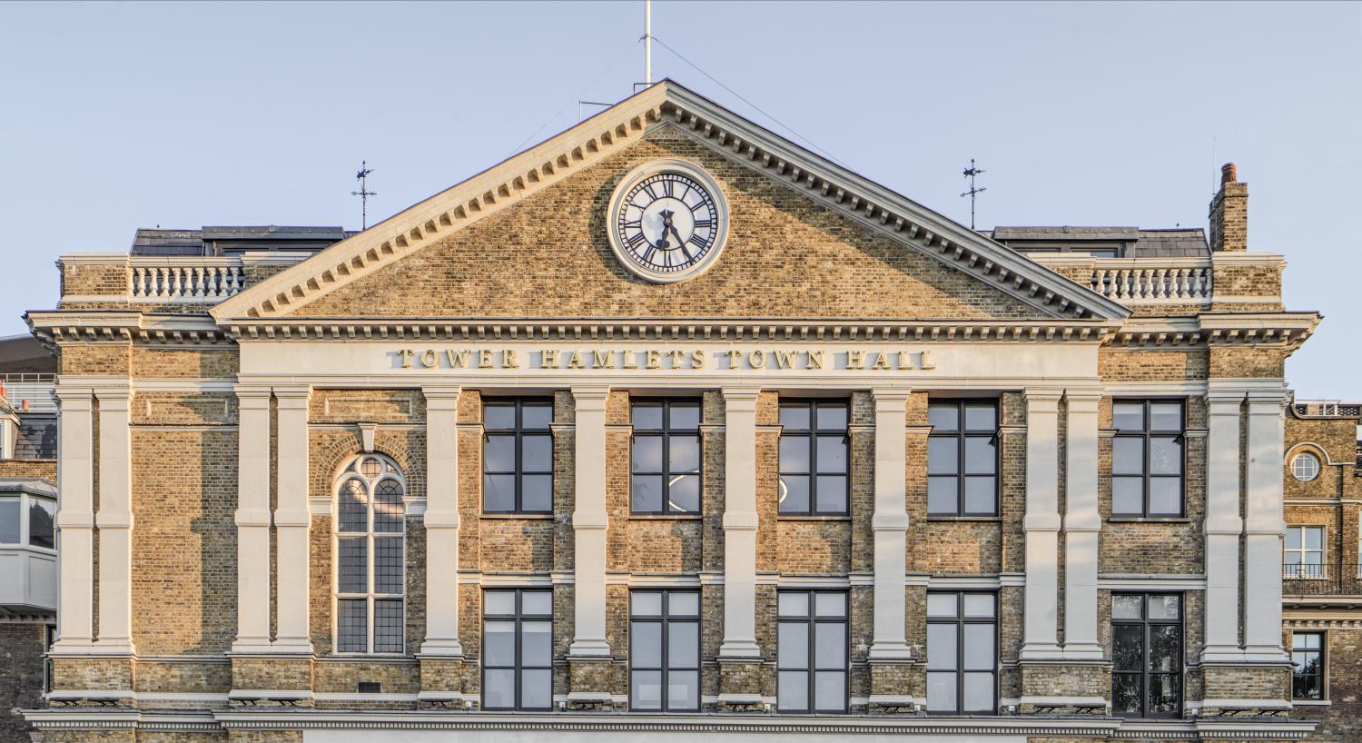 Photograph of a brick neo-classical building with a pediment reading "Tower Hamlets Town Hall"