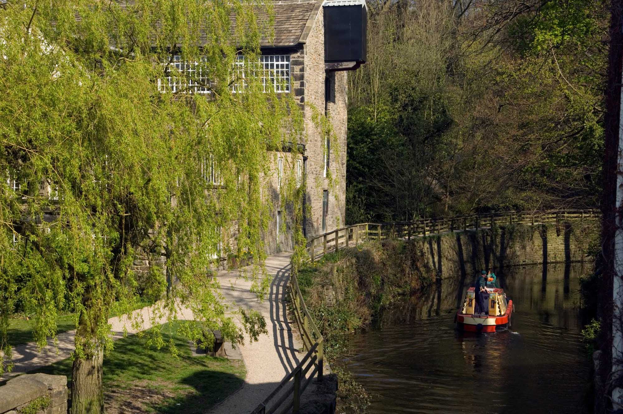 A barge going round a bend in the Leeds and Liverpool canal.