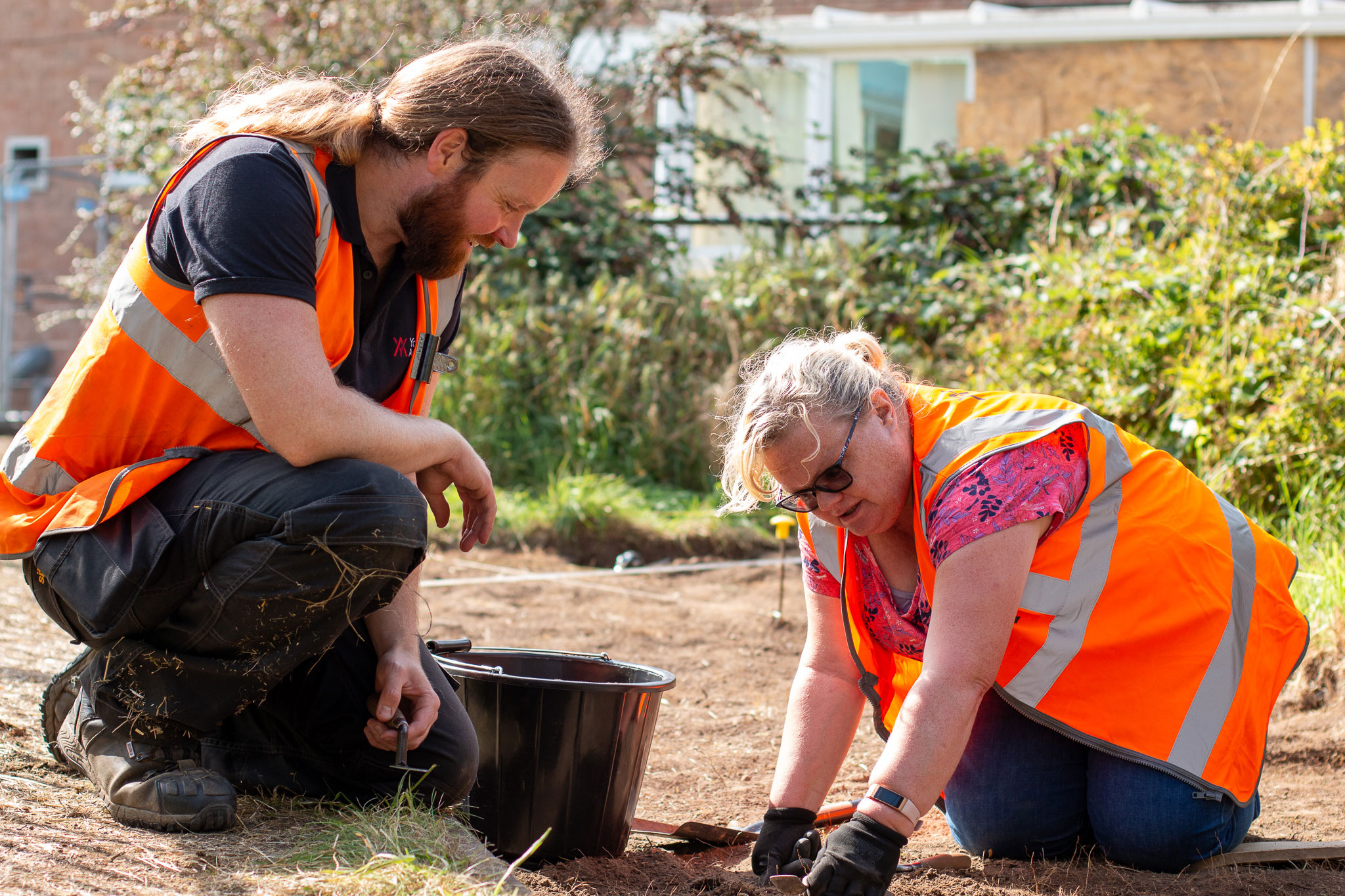 A man and a woman excavating at an archaeological dig