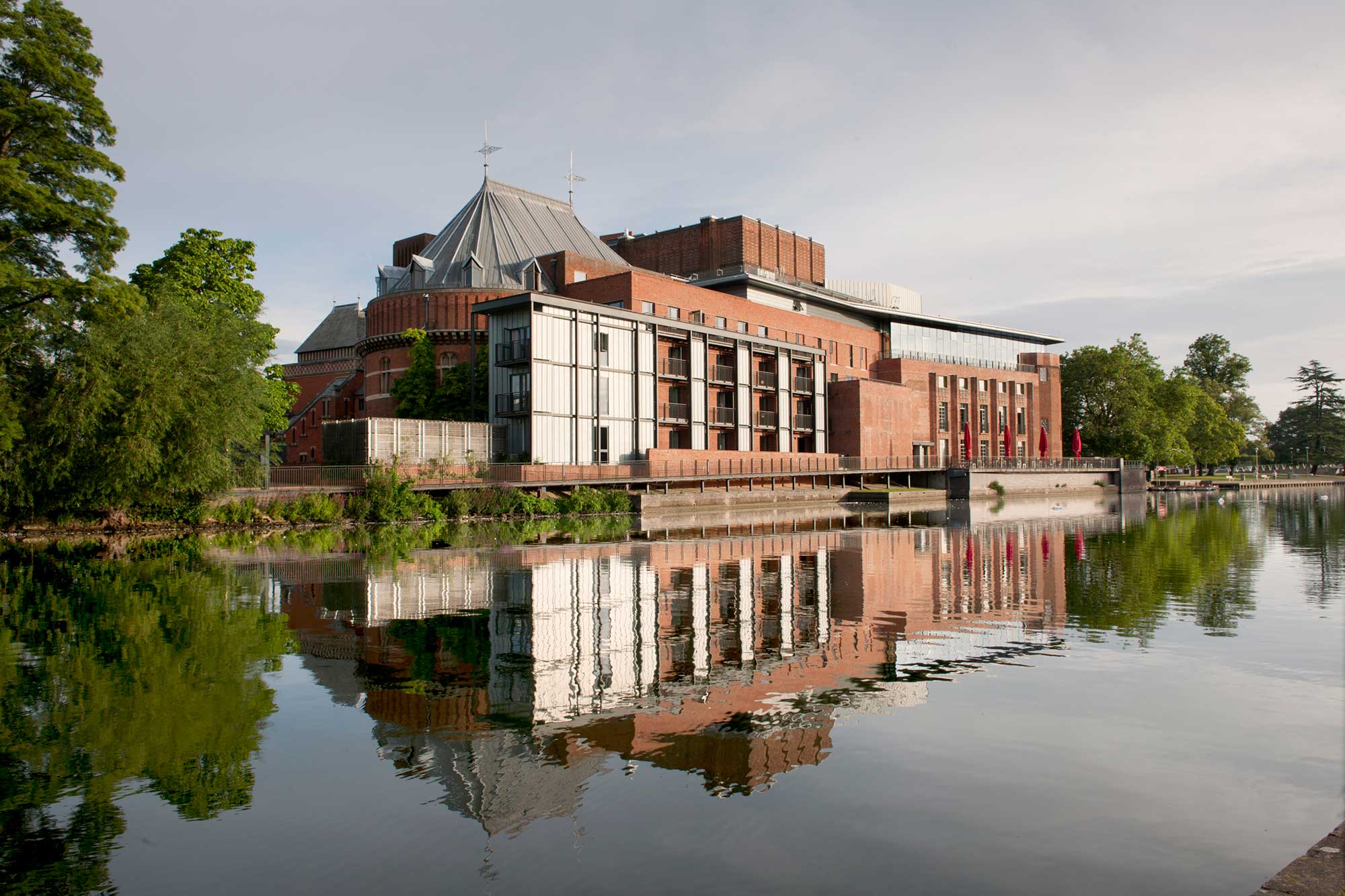 Royal Shakespeare Theatre reflected on the river surface.