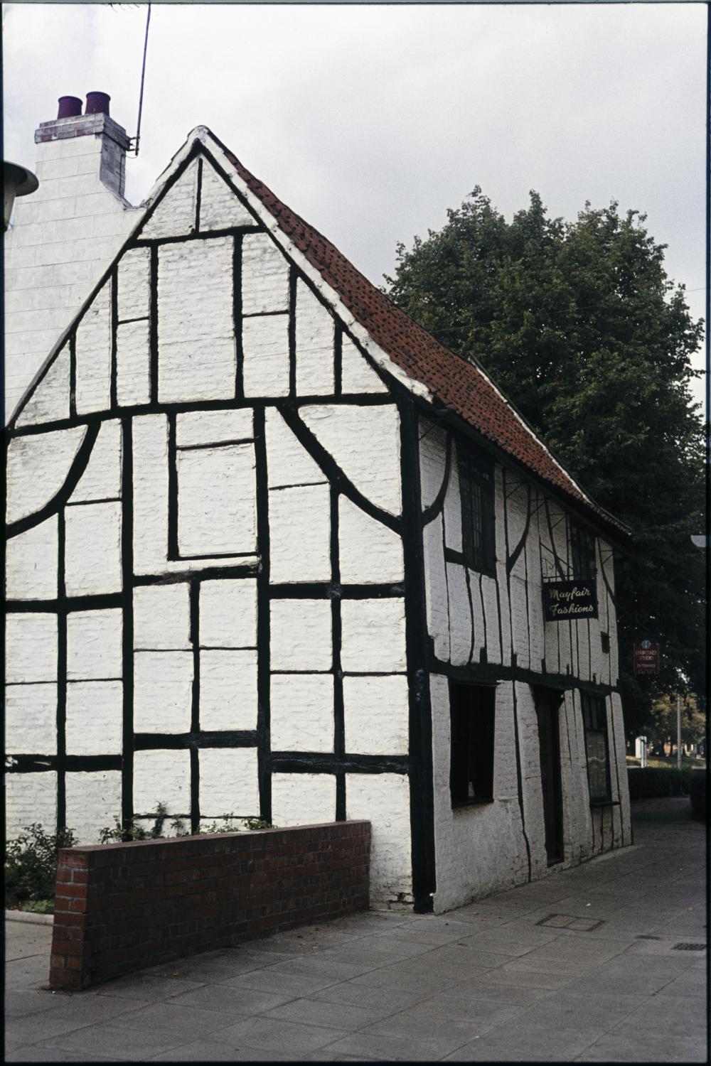 An old timber-framed building with black beams and white infill panels.