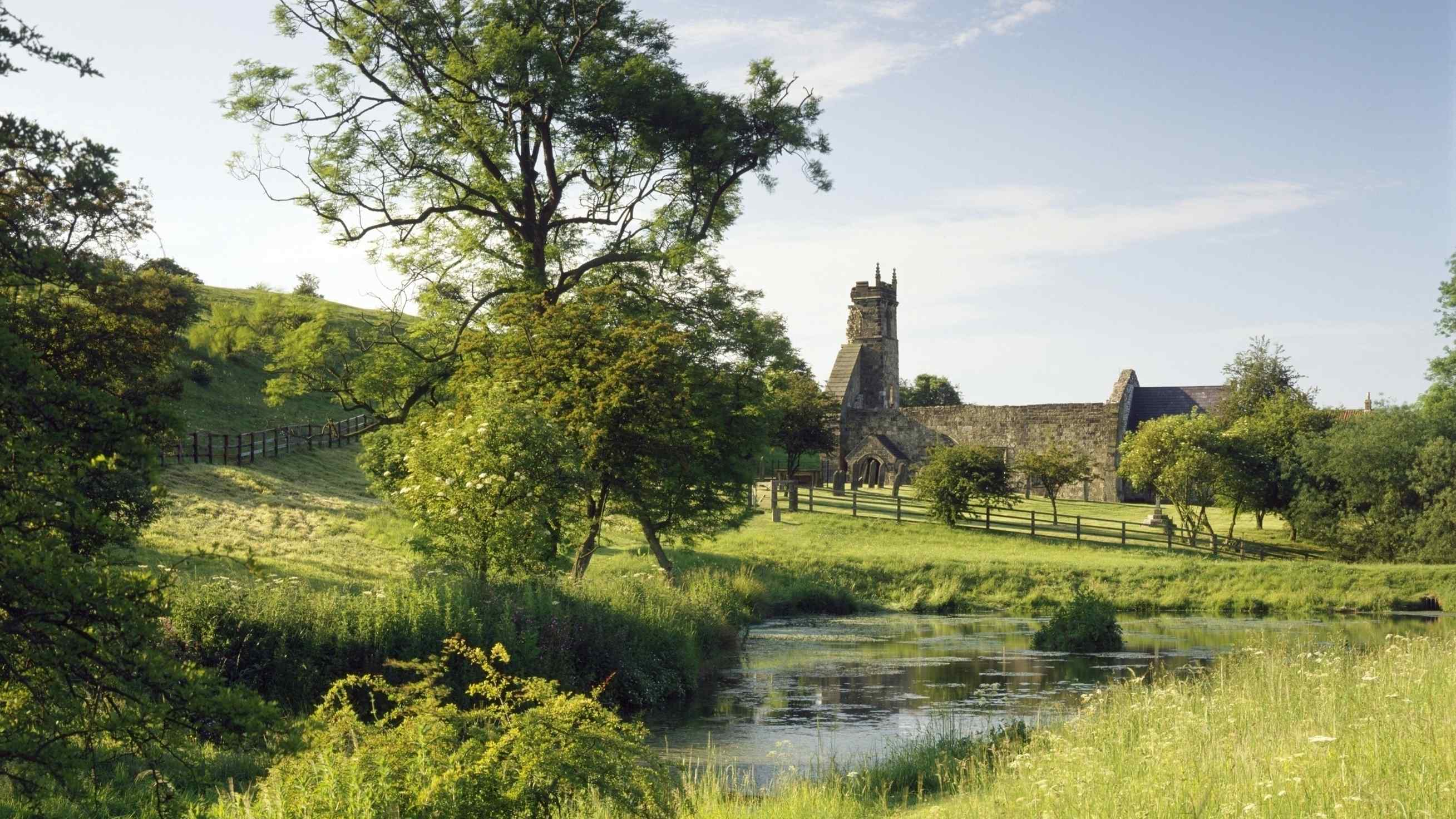 General view of Wharram Percy with church and medieval fish pond