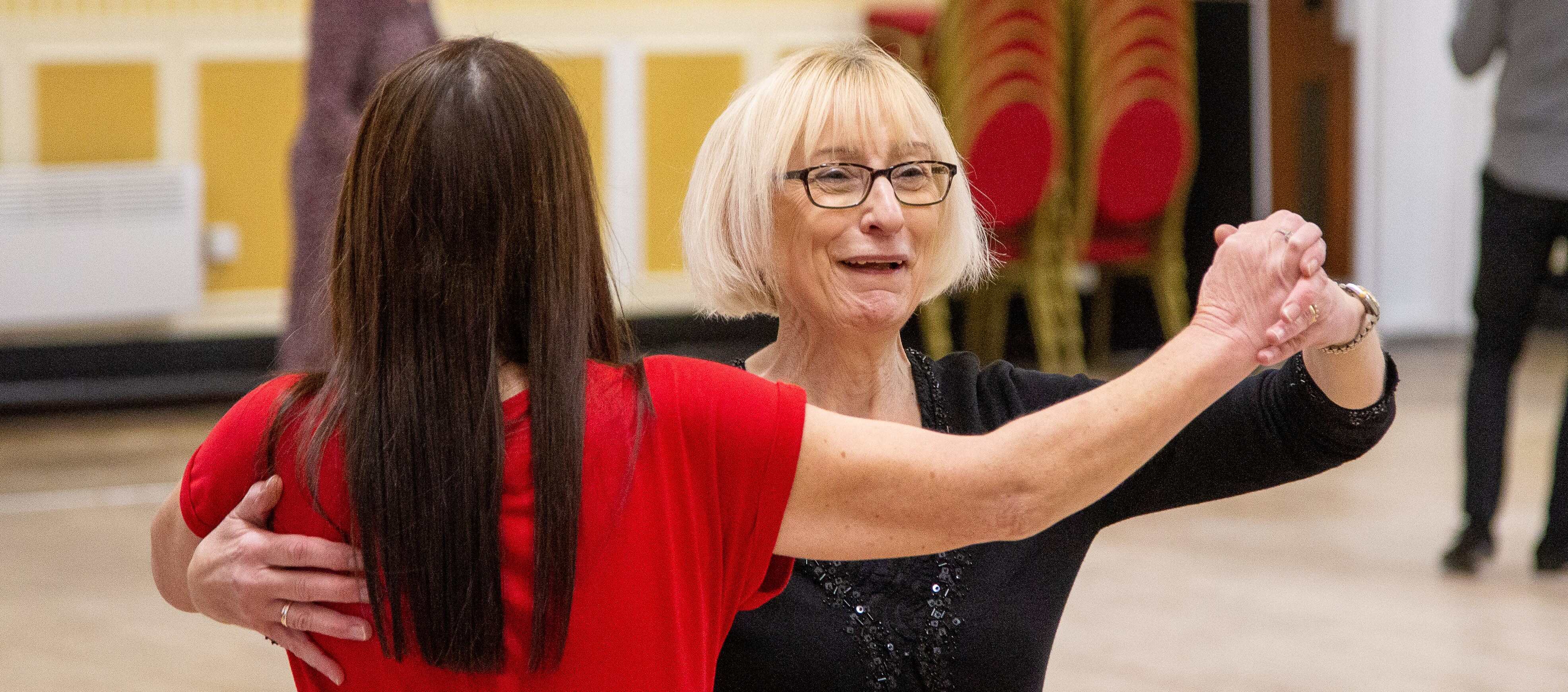Two ladies ball room dancing.