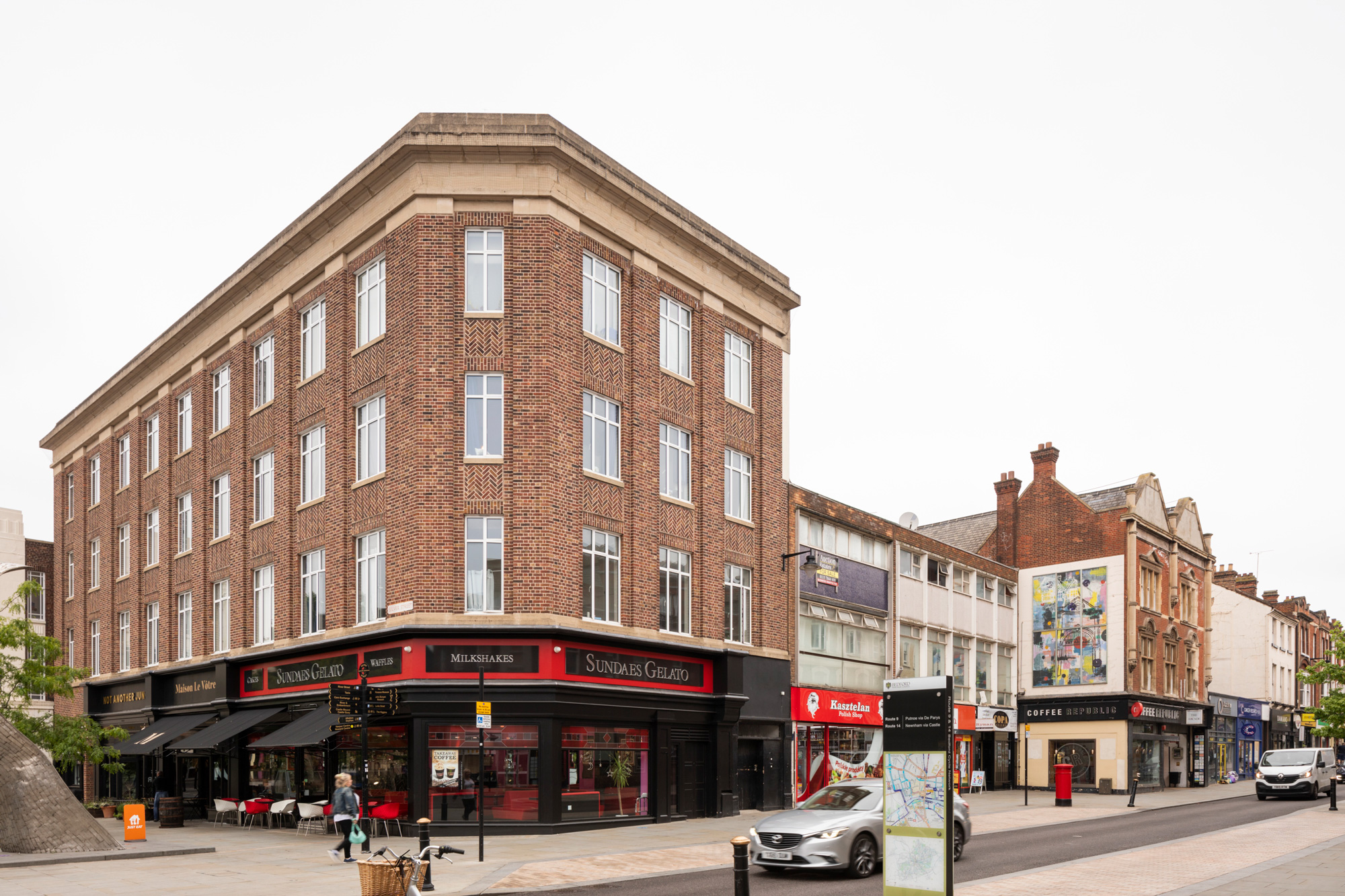 Photo of corner of Silver Street and High Street, Bedford with 4 storey brick building in foreground left.