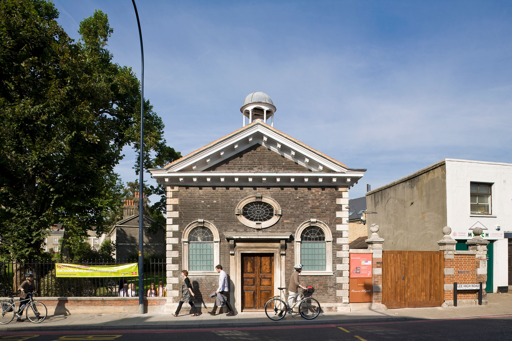 Image of the exterior of Boone's Chapel in London, showing the building and surrounding railings with attac.hed banners