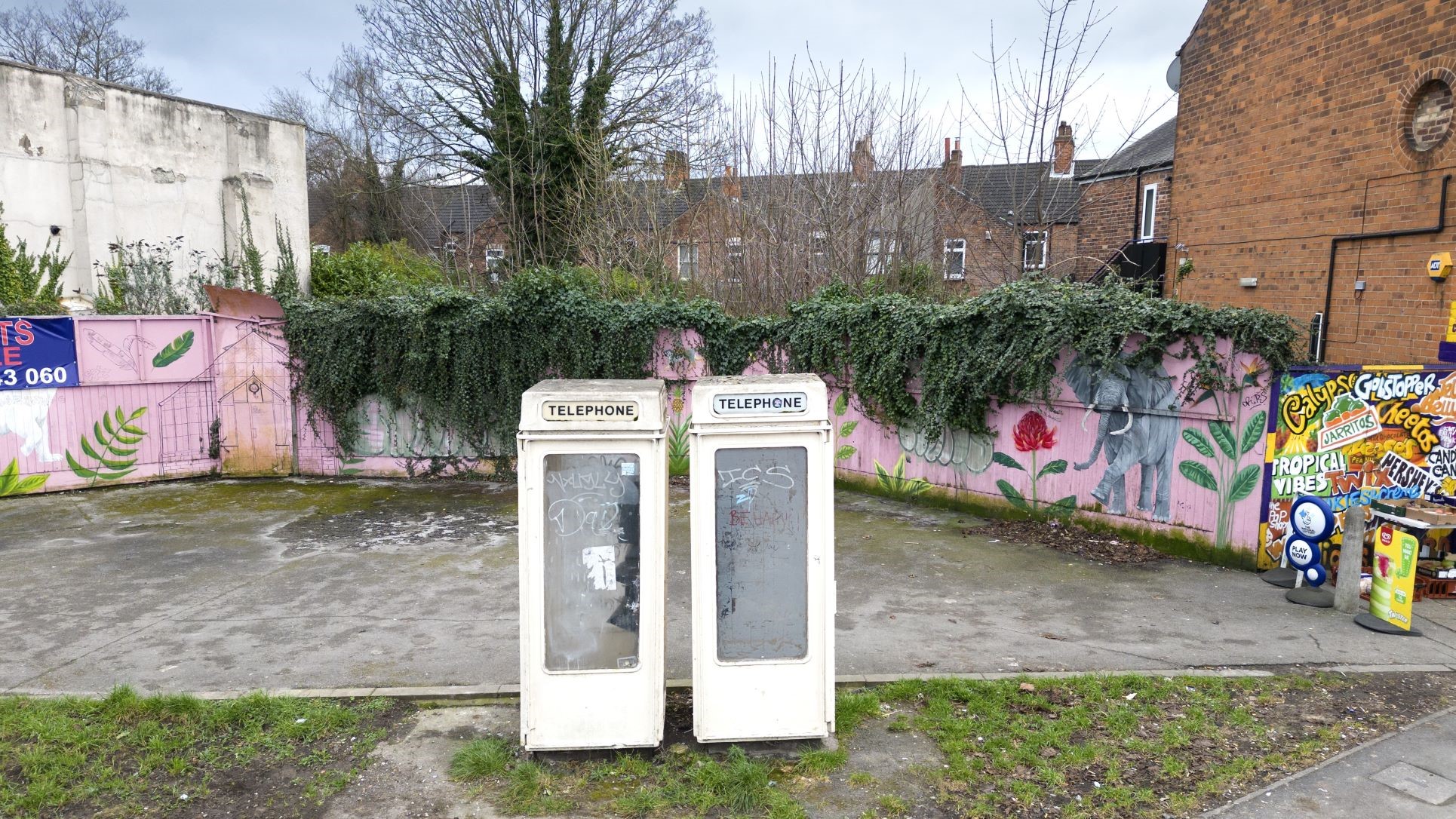 Two cream coloured phone boxes side by side. 