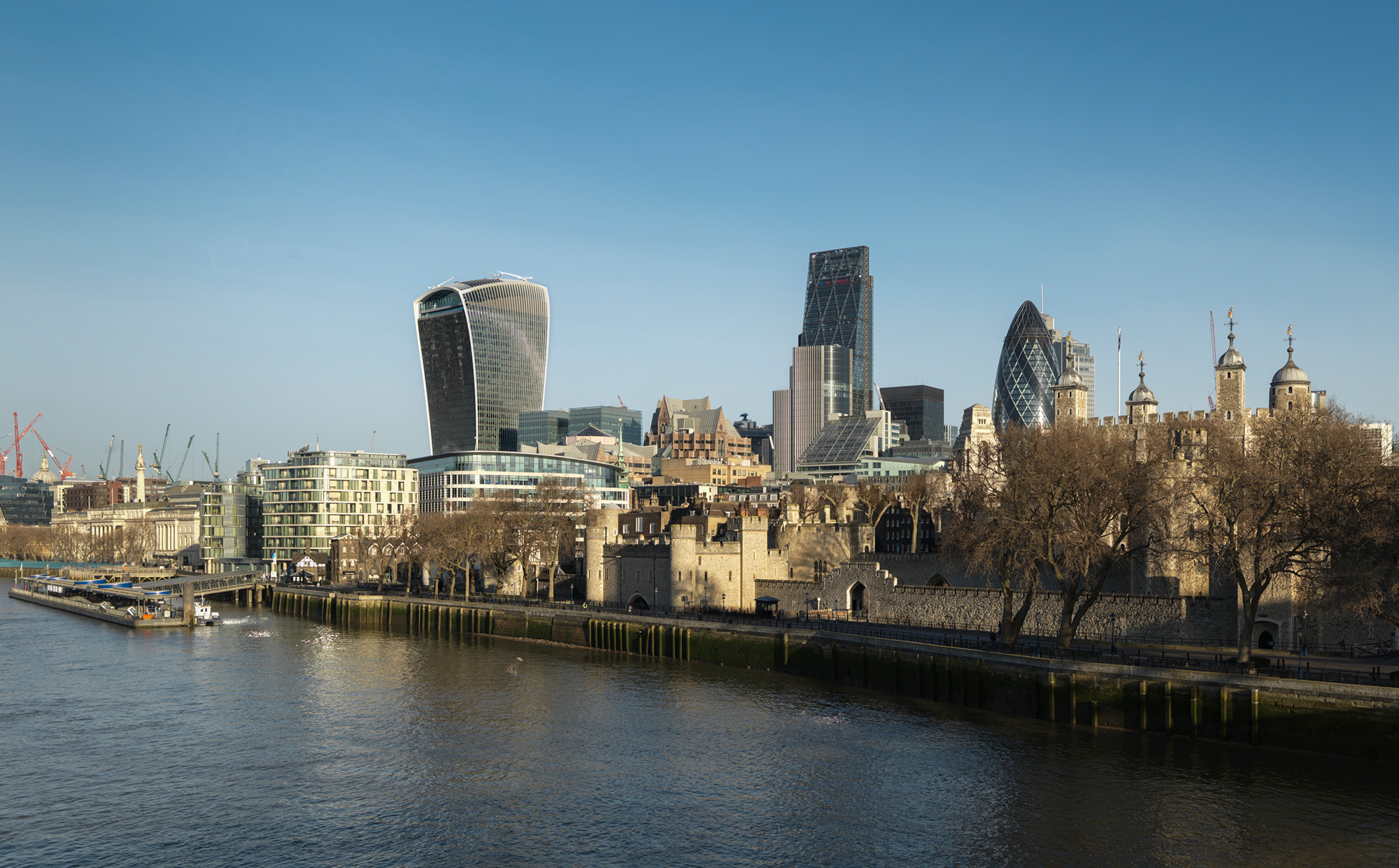 General view of the City of London skyline from Tower Bridge, showing prominent buildings including the Tower of London, 30 Mary Axe (the 'Gherkin'), the Leadenhall building (the 'Cheesegrater') and 20 Fenchurch Street (the 'Walkie Talkie')