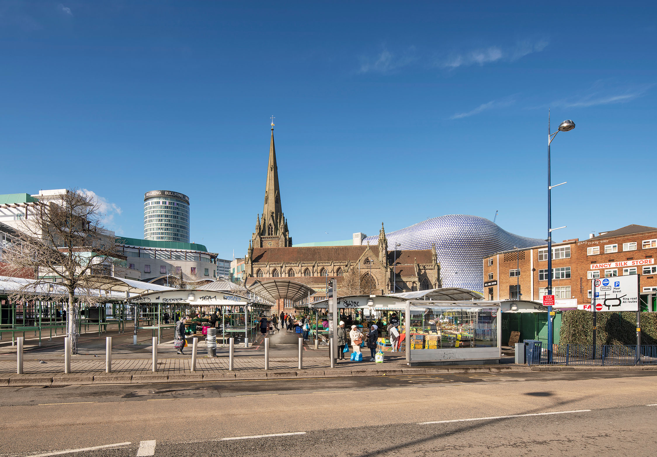 An urban street scene of the area around St Martin's Church and the Bull Ring in Birmingham.