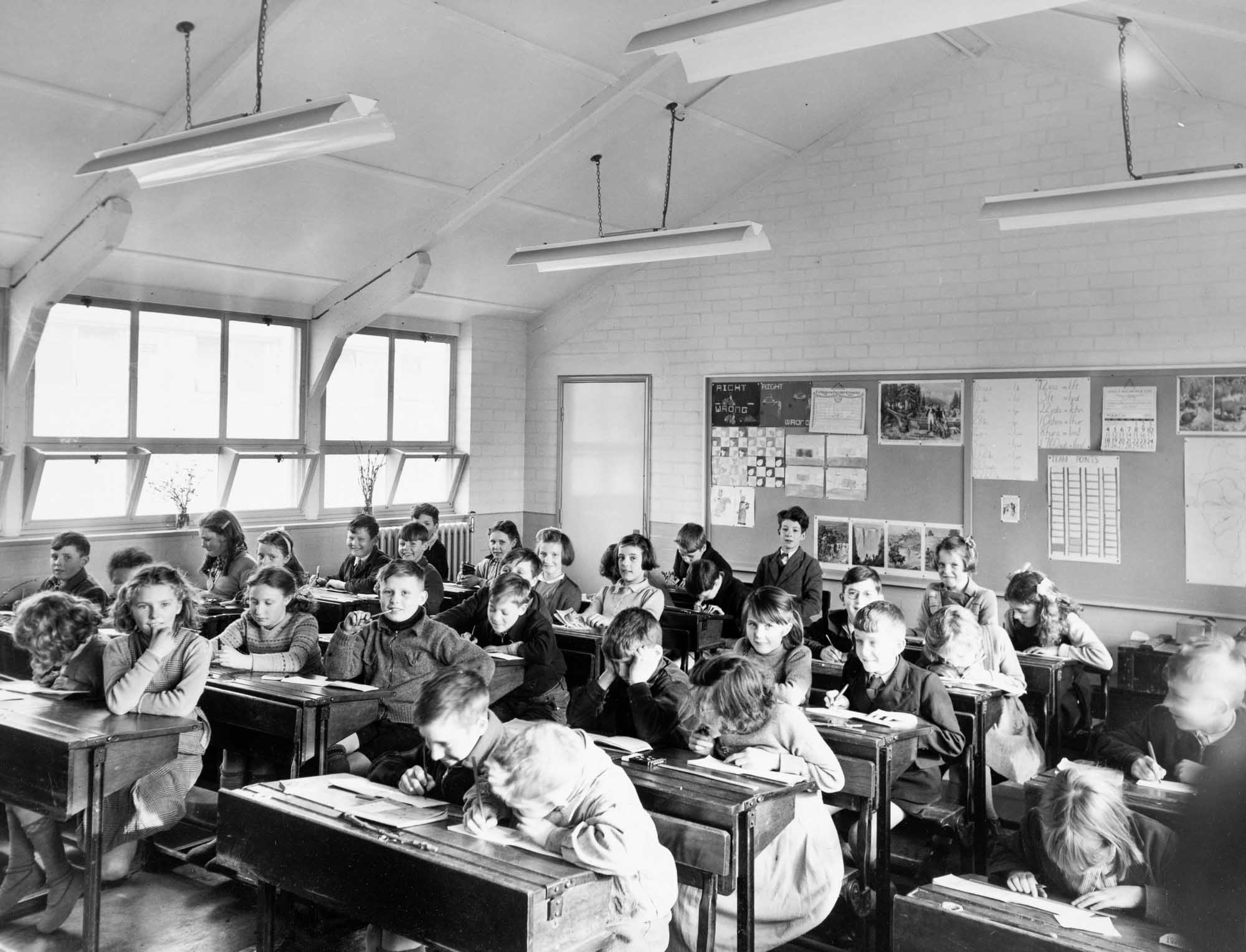 Black and white photo of children studying at their desks in a classroom at Cleator Moor School