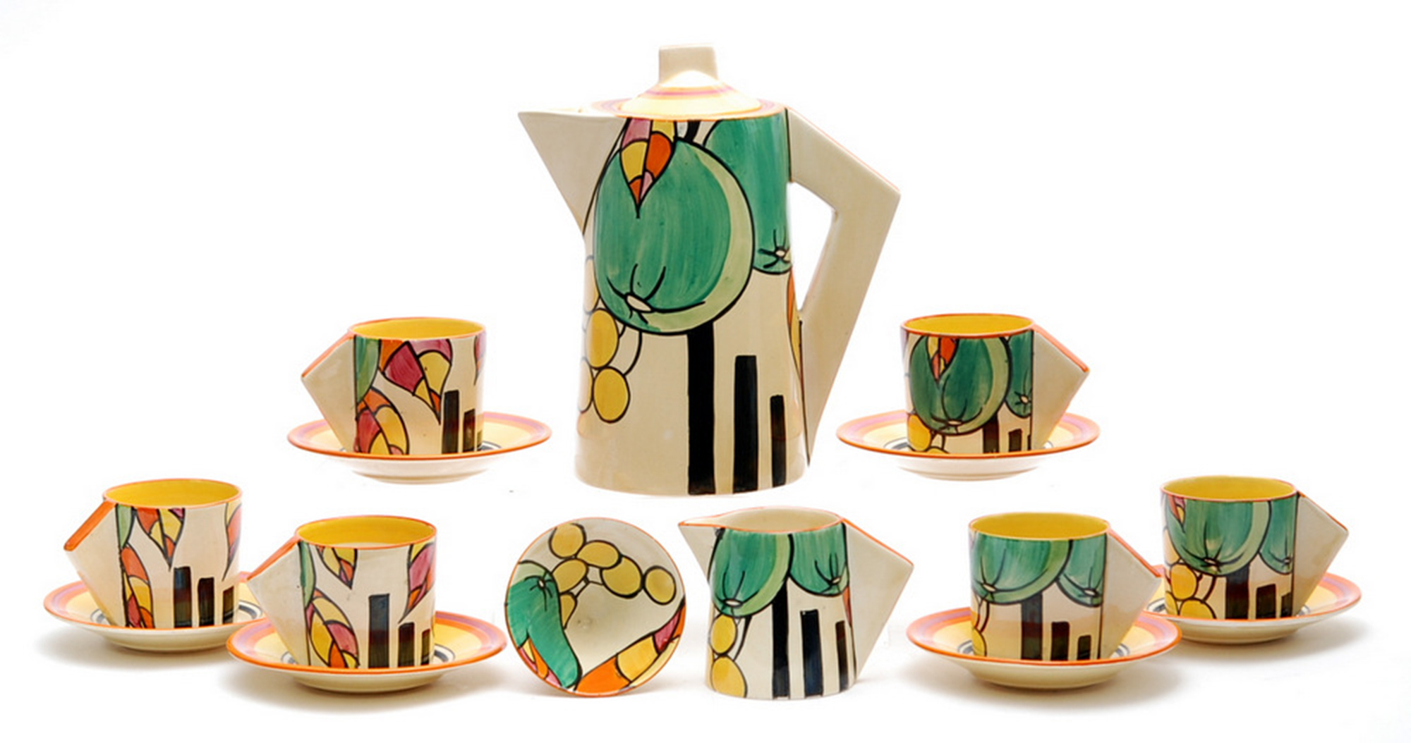 A decorative coffee set of pots, cups and saucers on a plain white background
