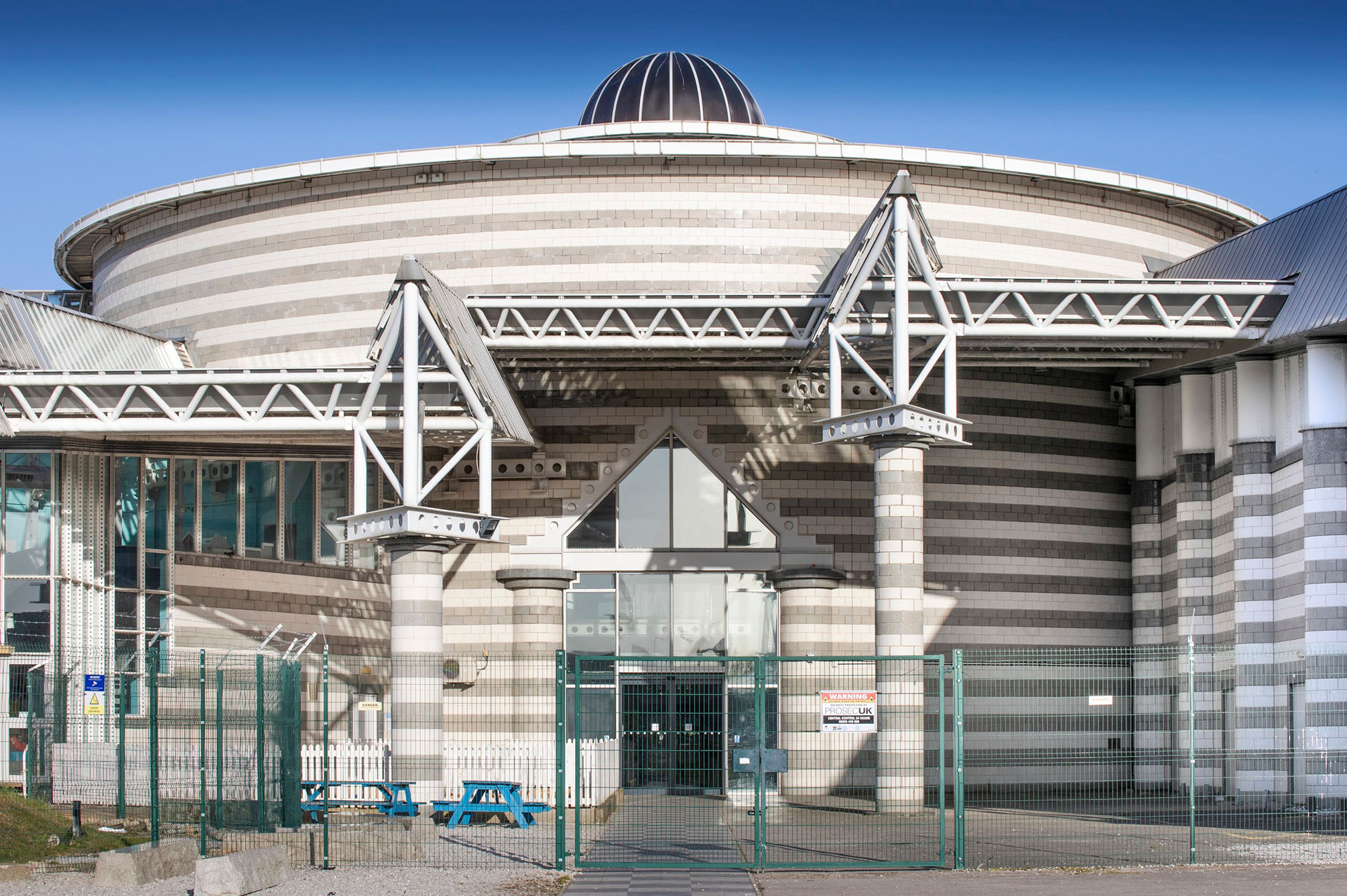 Exterior view of a leisure centre with a large domed roof structure