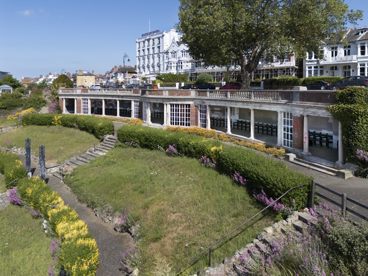 The curving front of the Sun Shelter in Southend-on-Sea with landscaped grounds to the front.
