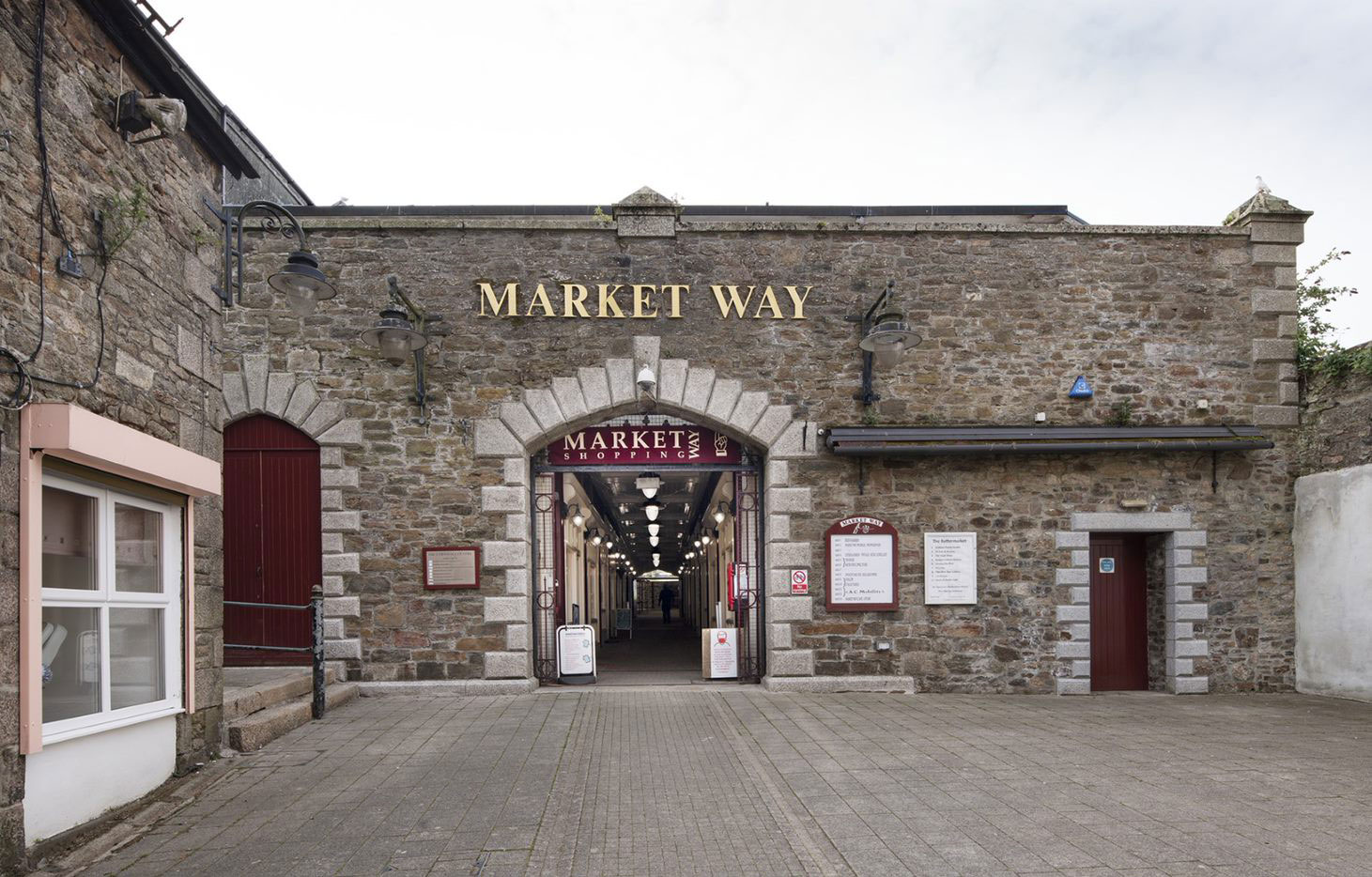 Stone-built elevation with the inscription ‘Market Way’ and a central opening.