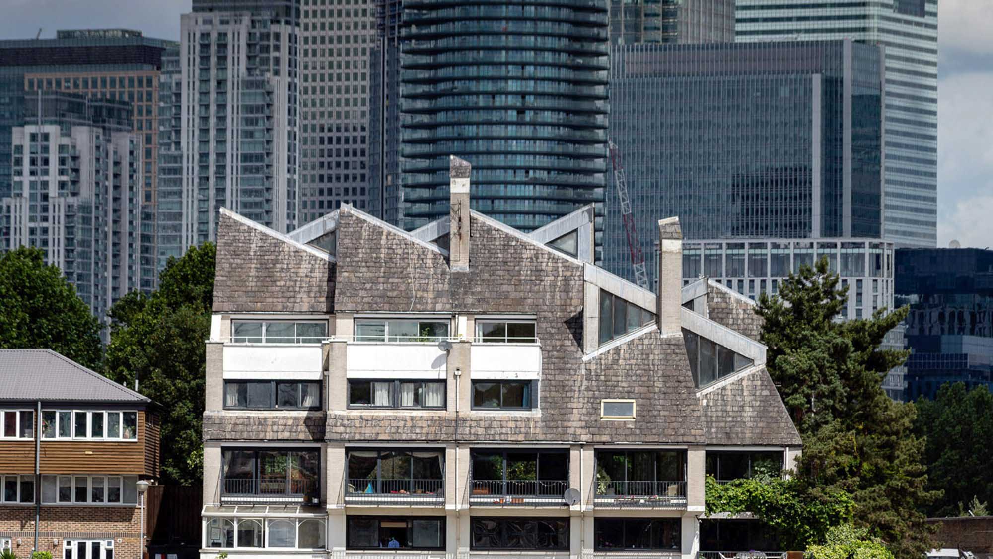 A distinctive terrace of houses and other buildings with Canary Wharf in the background