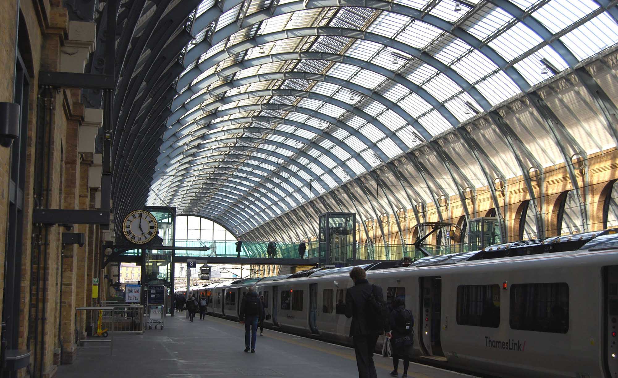 Passengers walking along a platform at King's Cross Station