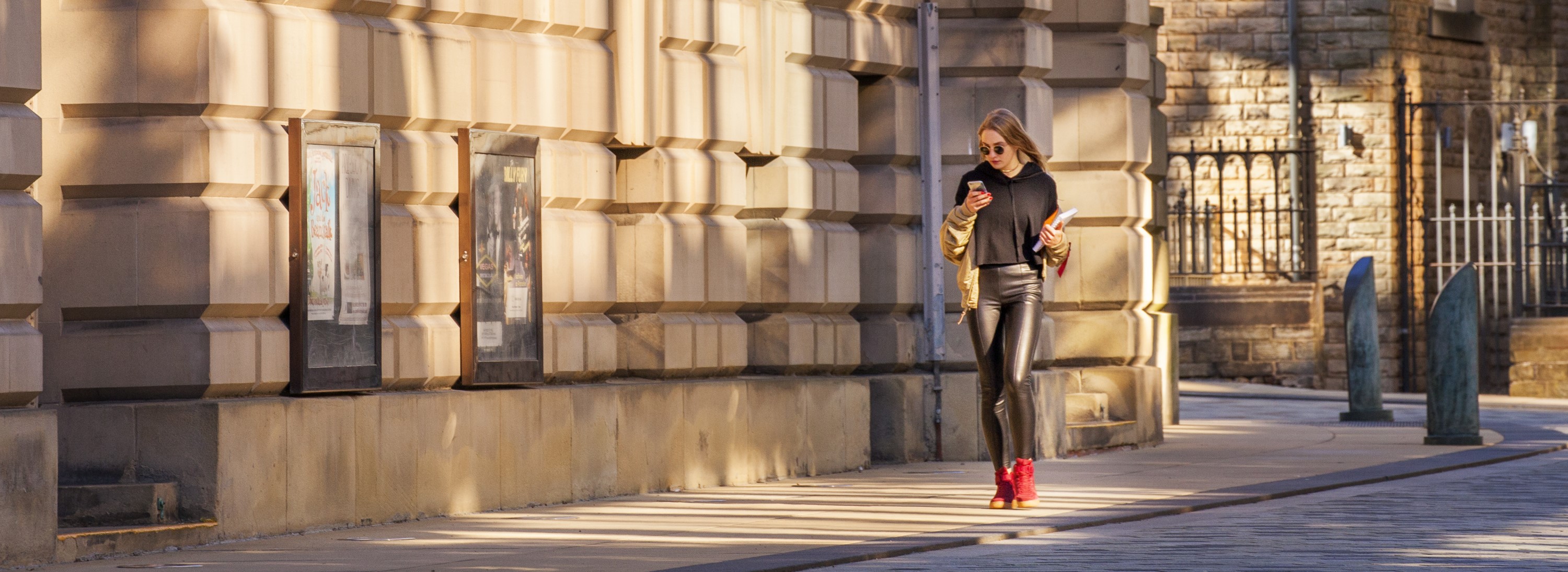 A woman walking down a street. 