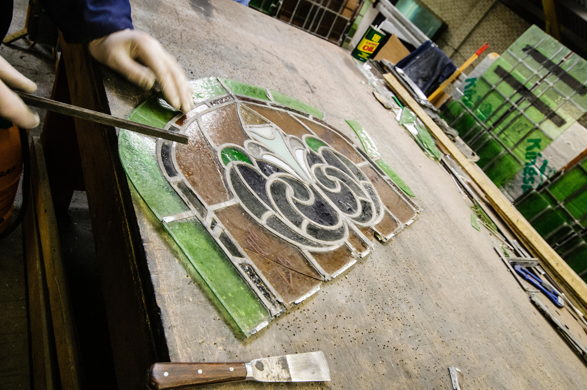 Stained glass window on a work bench undergoing restoration.