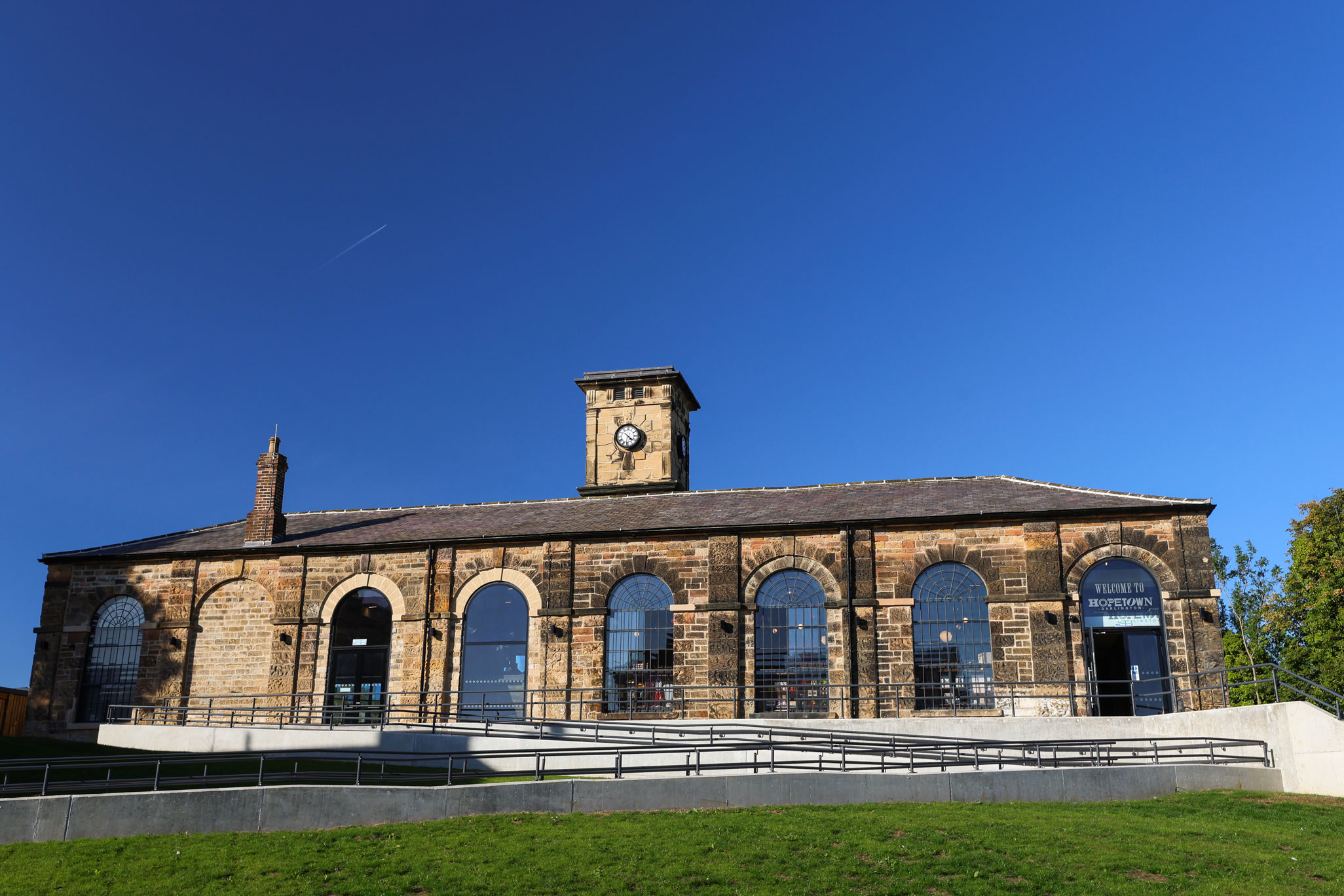 Exterior view of restored stone goods shed.