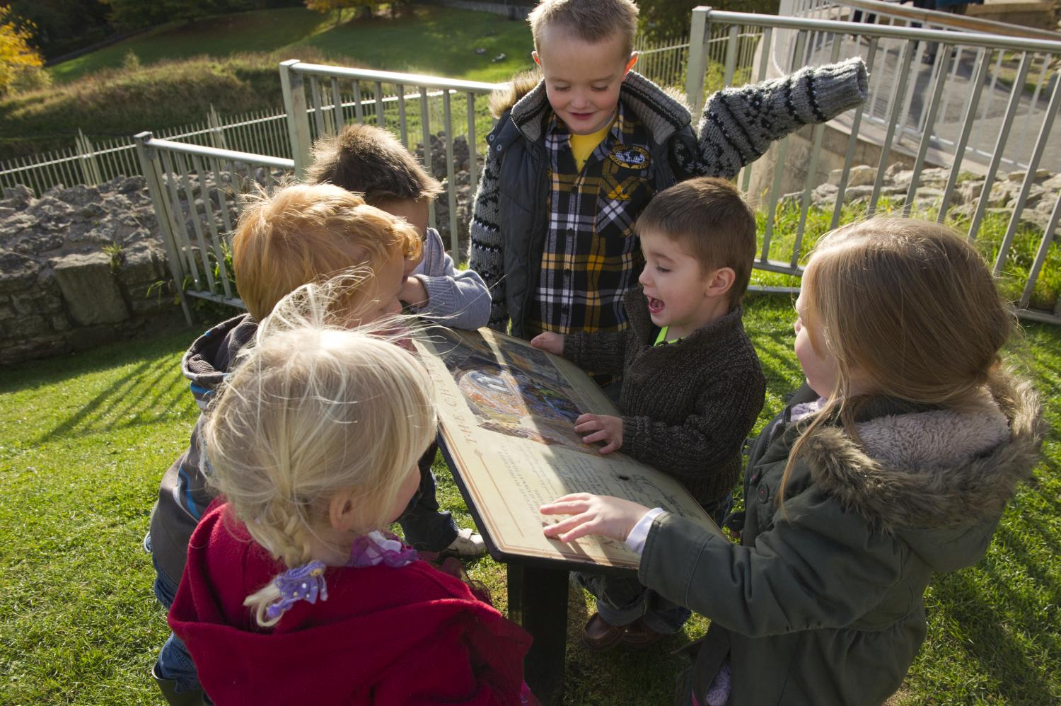 Six children stood around an informational sign at Conisbrough Castle
