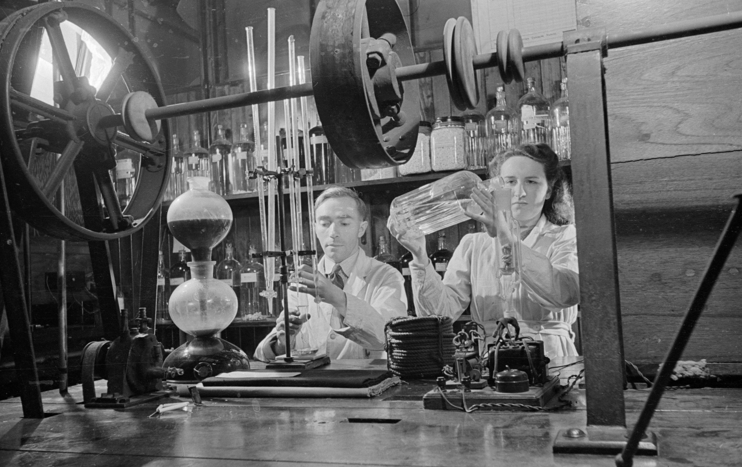 Man and woman working with scientific equipment.