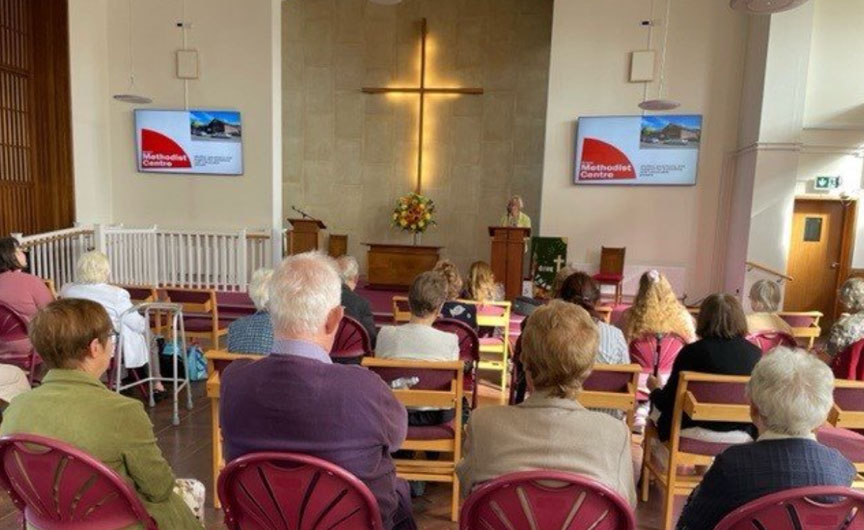 People are seated in a church.