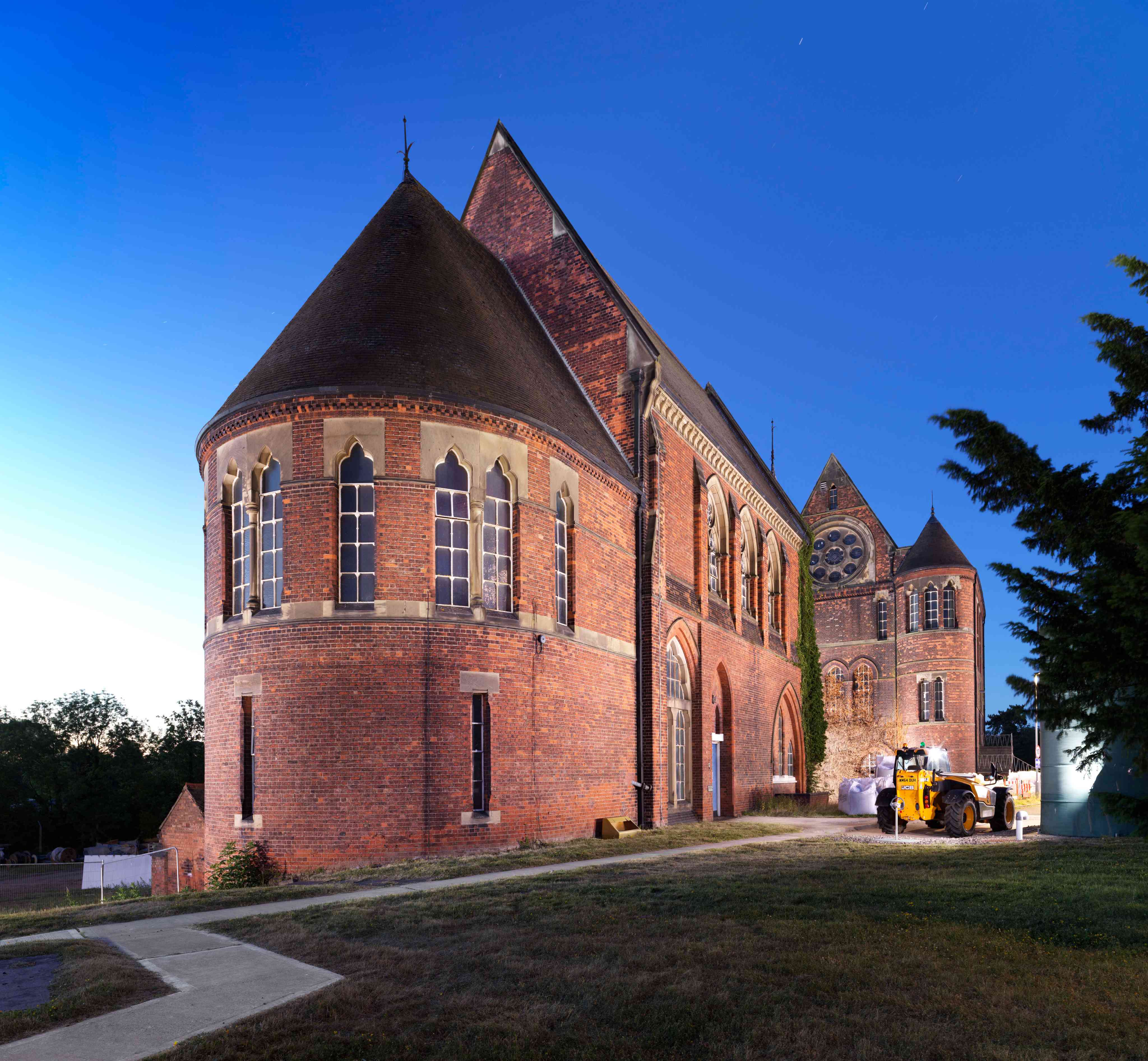 Whitacre Pumping Station on a summer's evening, with a brilliant blue sky in the background.