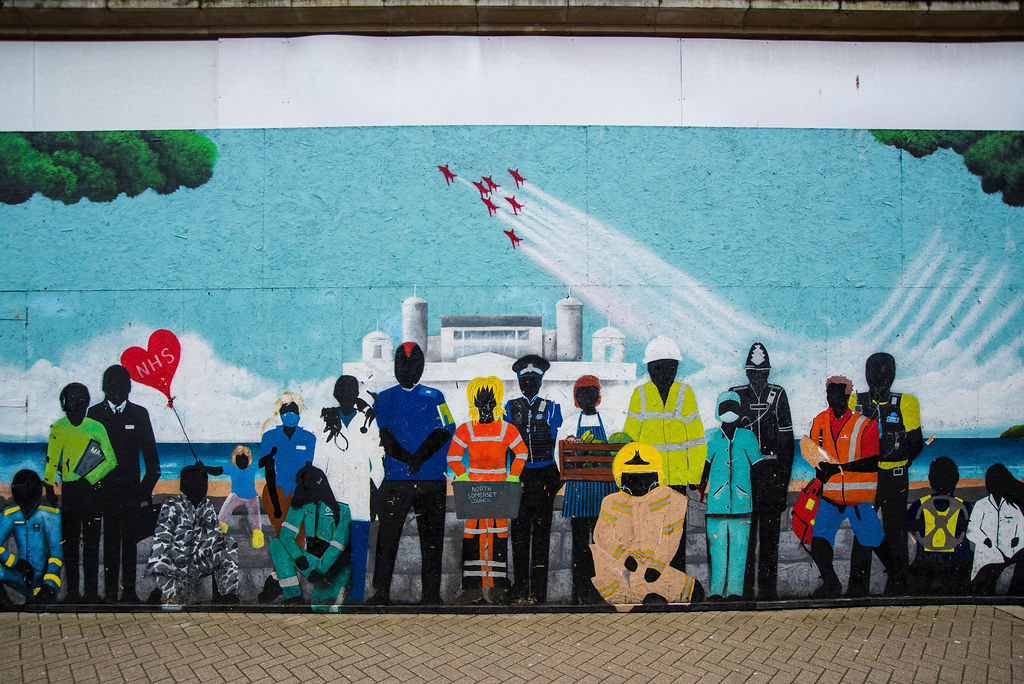 A mural depicting people in different vocations.