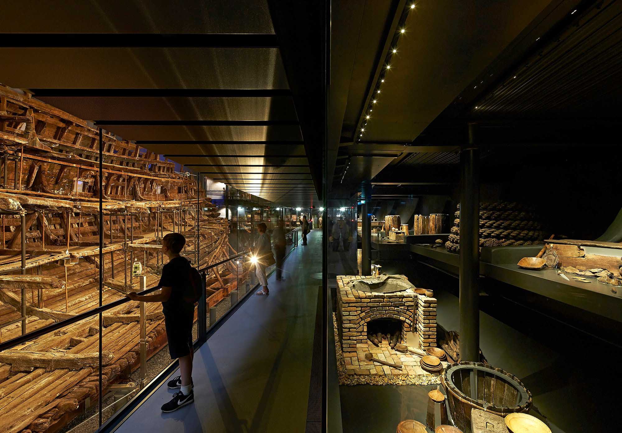 People viewing artefacts at exhibition