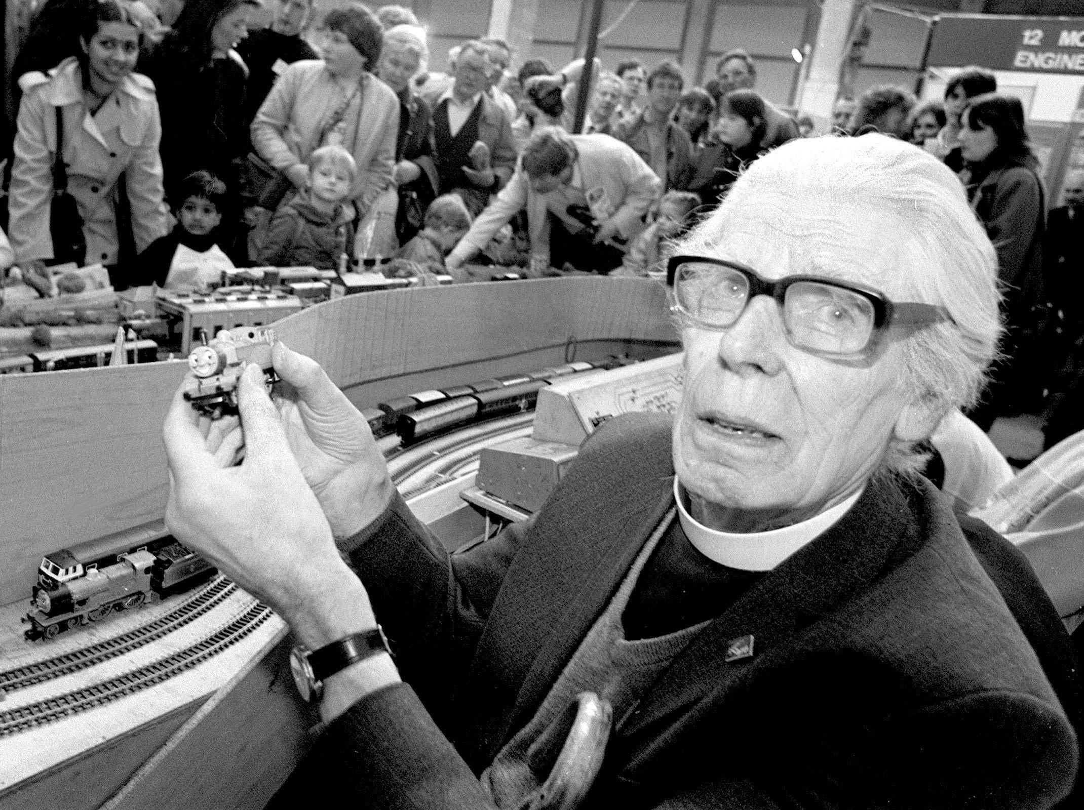 Reverend Wilbert Awdry holding a toy train.