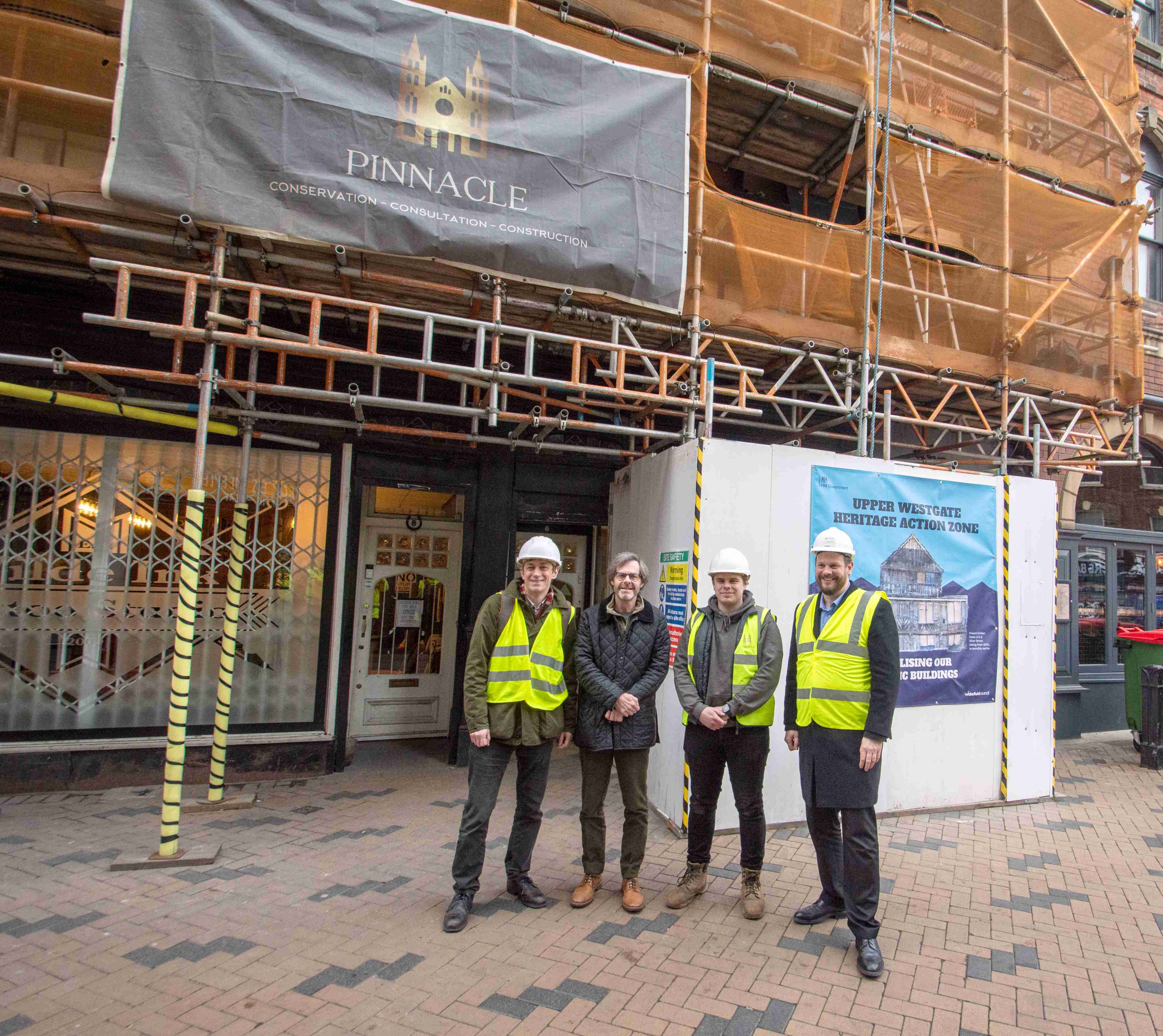 Four men looking at the camera. 