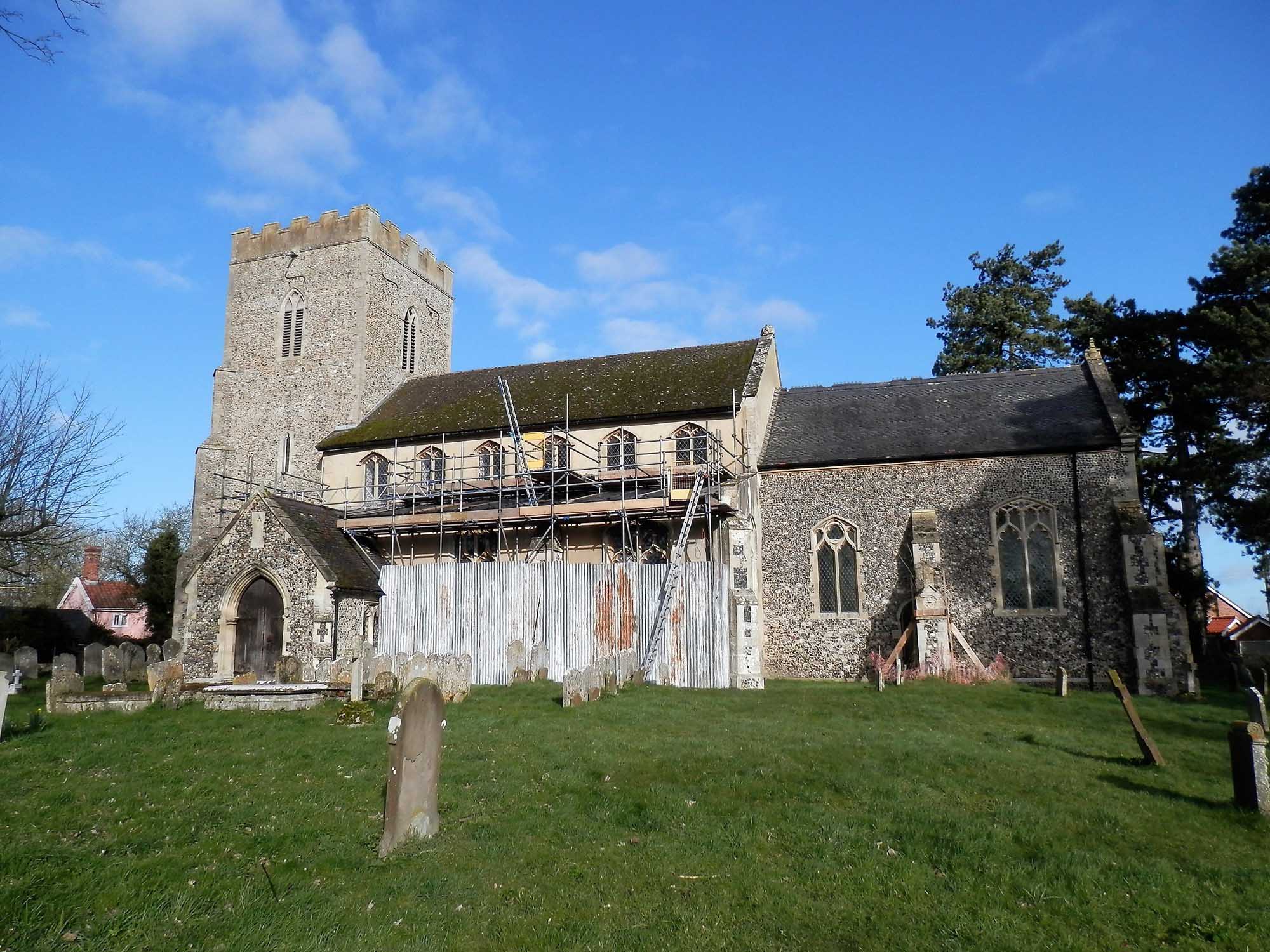 Image of a parish church with scaffolding along one side.