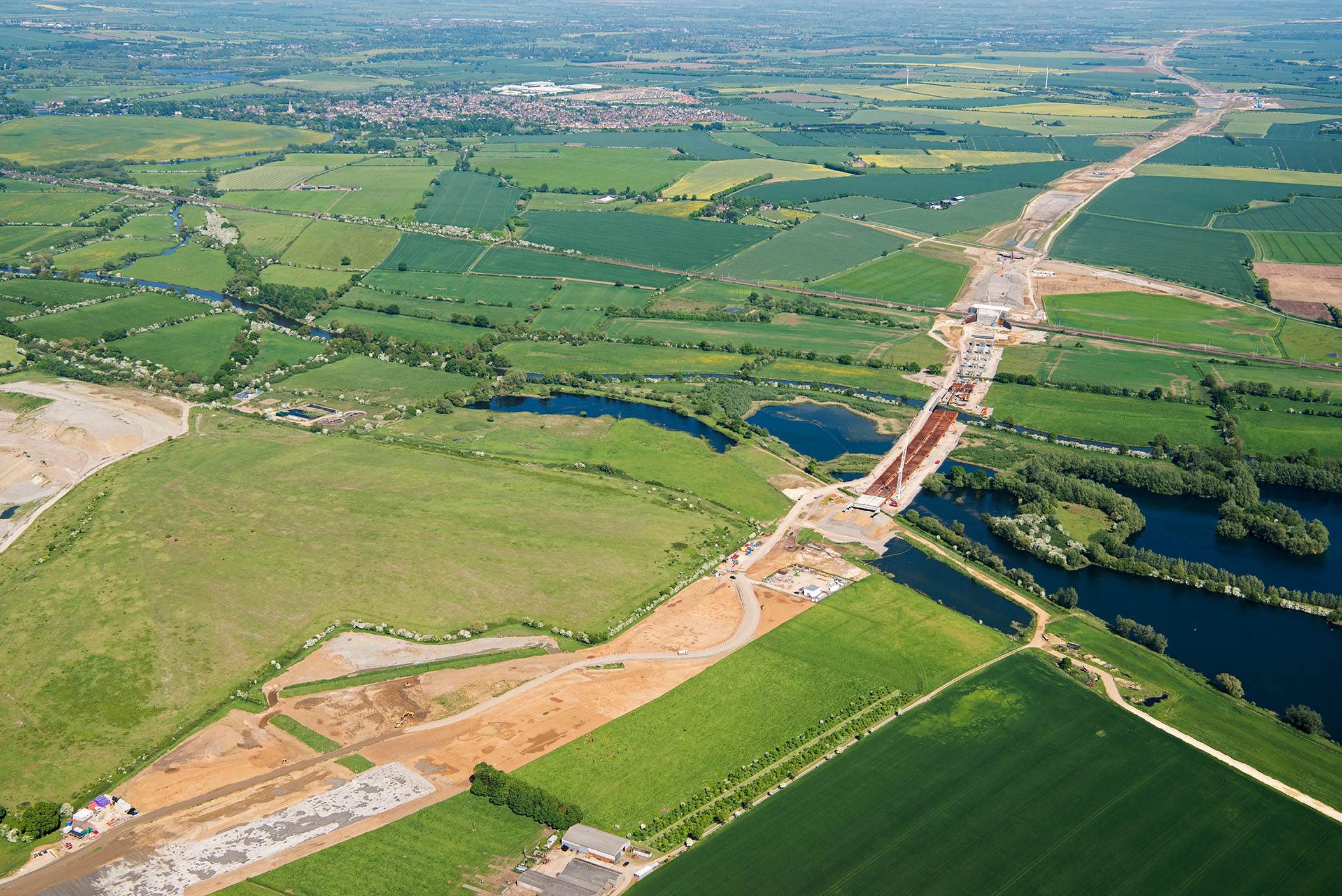 An aerial photograph showing archaeological excavations and surrounding countryside along the road improvement scheme for the A14 in Cambridgeshire, where it crosses over the Great Ouse river.